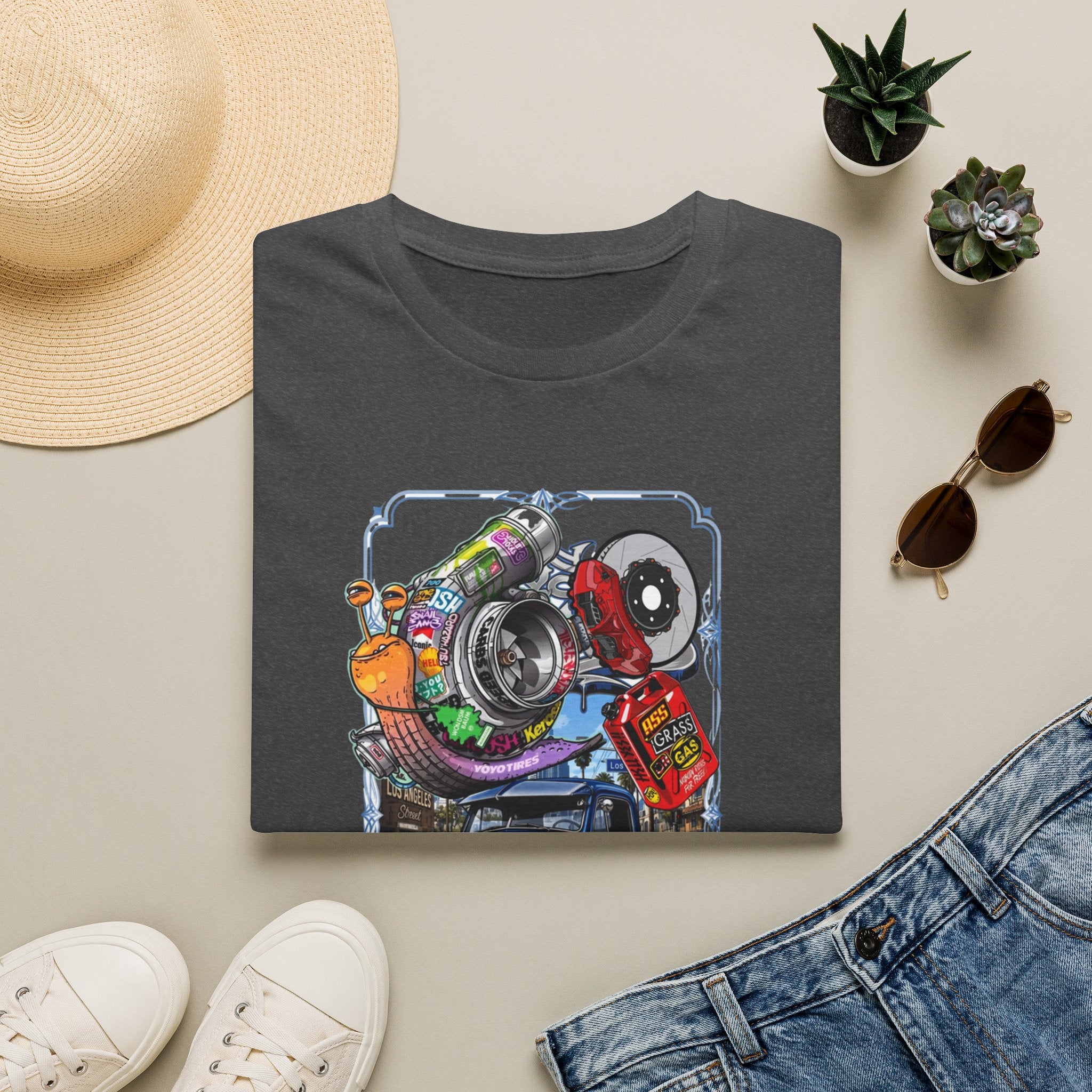 Turbocharged Snail Gearhead Car Parts print on a Dark Heather t-shirt, folded beside a straw hat and jeans