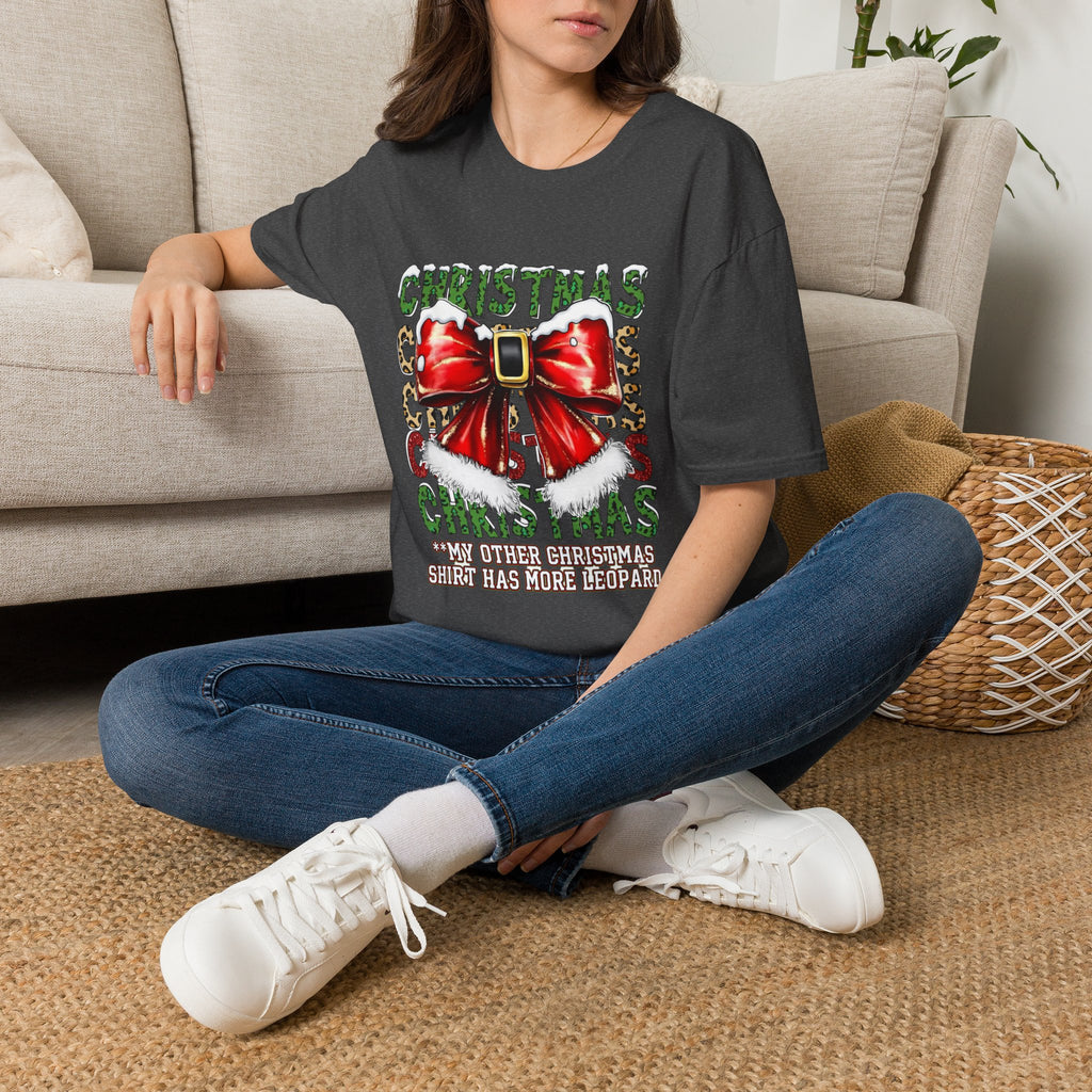 Stacked Christmas Leopard Print Santa Belt Bow t-shirt in Dark Heather, worn by a woman seated on a rug