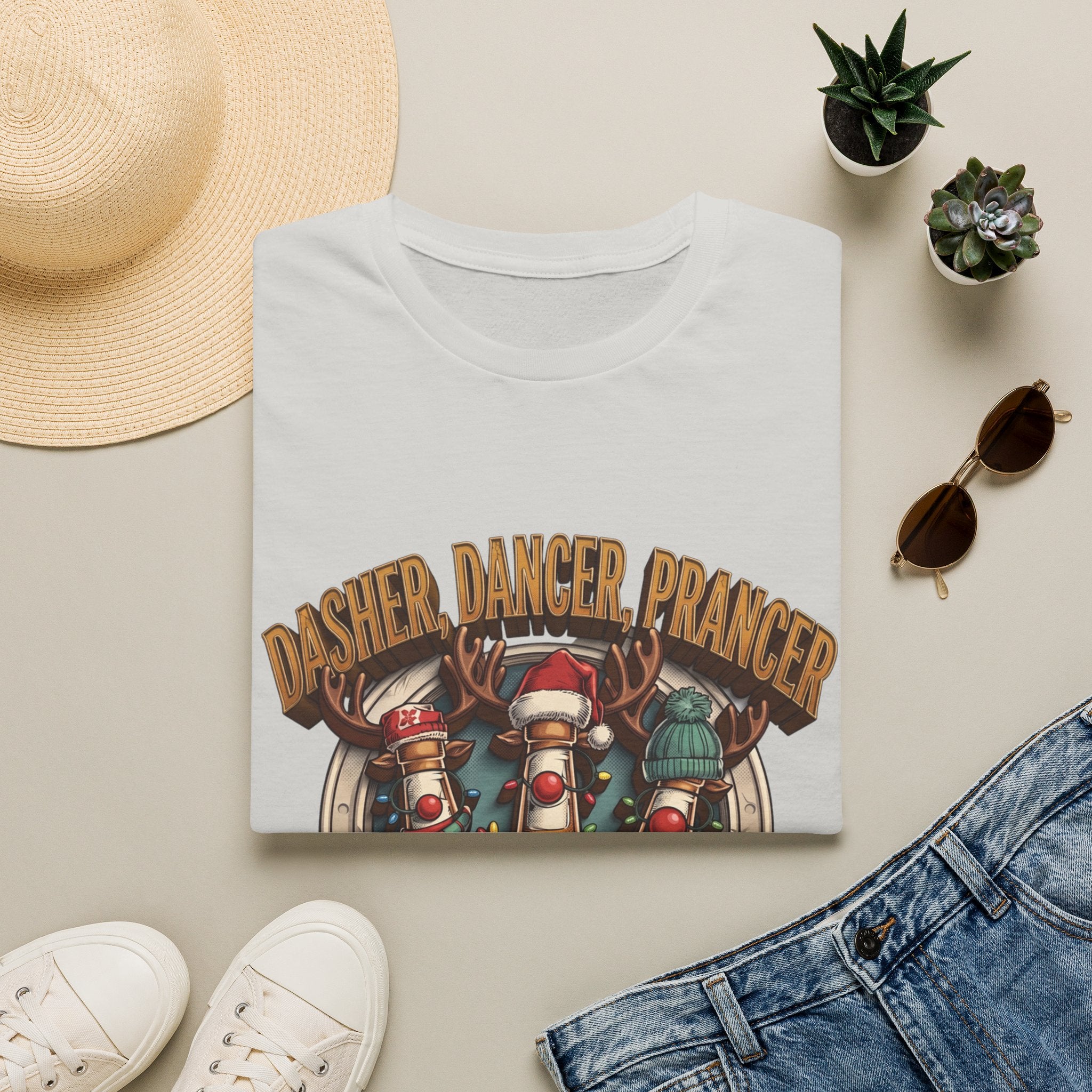 Dasher Dancer Prancer Reinbeer Christmas Beer print on an Ice Grey t-shirt, folded beside a straw hat and jeans