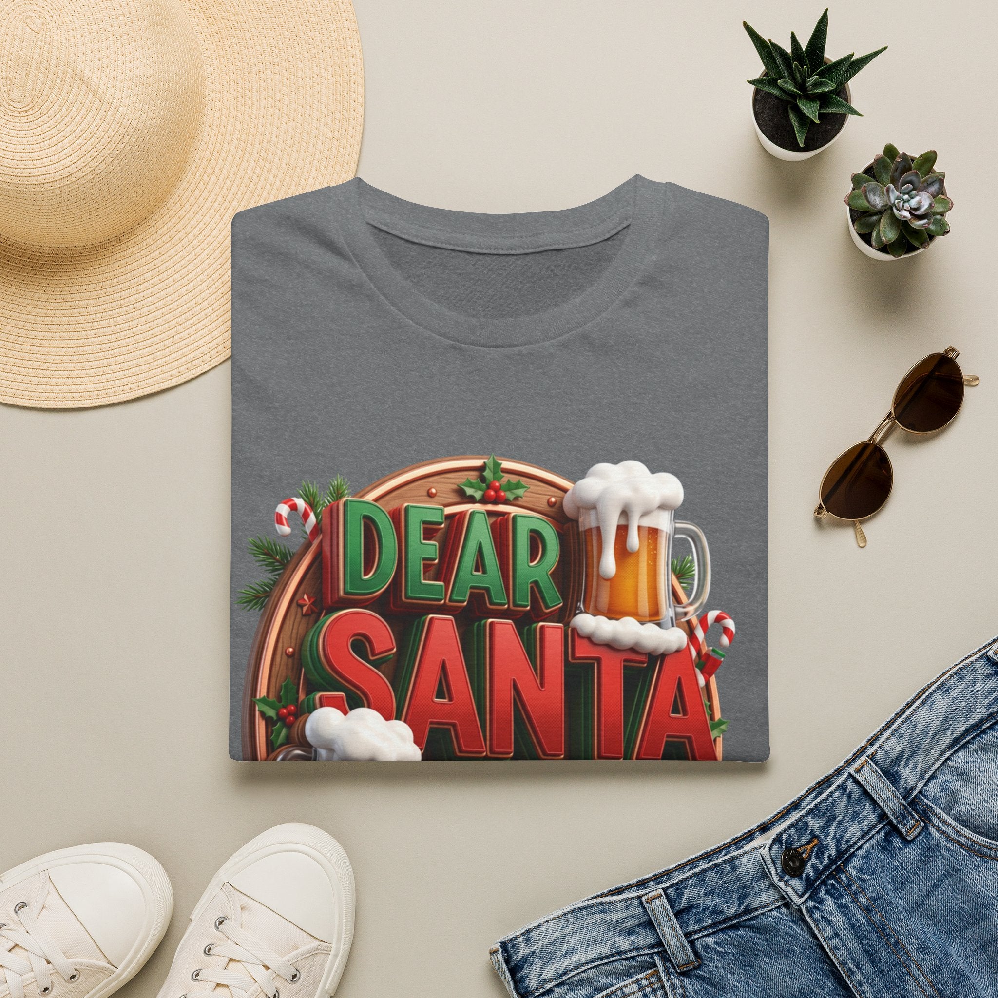 Dear Santa Just Bring Beer Funny print on a Graphite Heather t-shirt, folded beside a straw hat and jeans