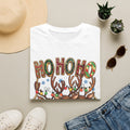 Reindeer Trio Ho Ho Ho Christmas Lights print on a White t-shirt, folded beside a straw hat and jeans