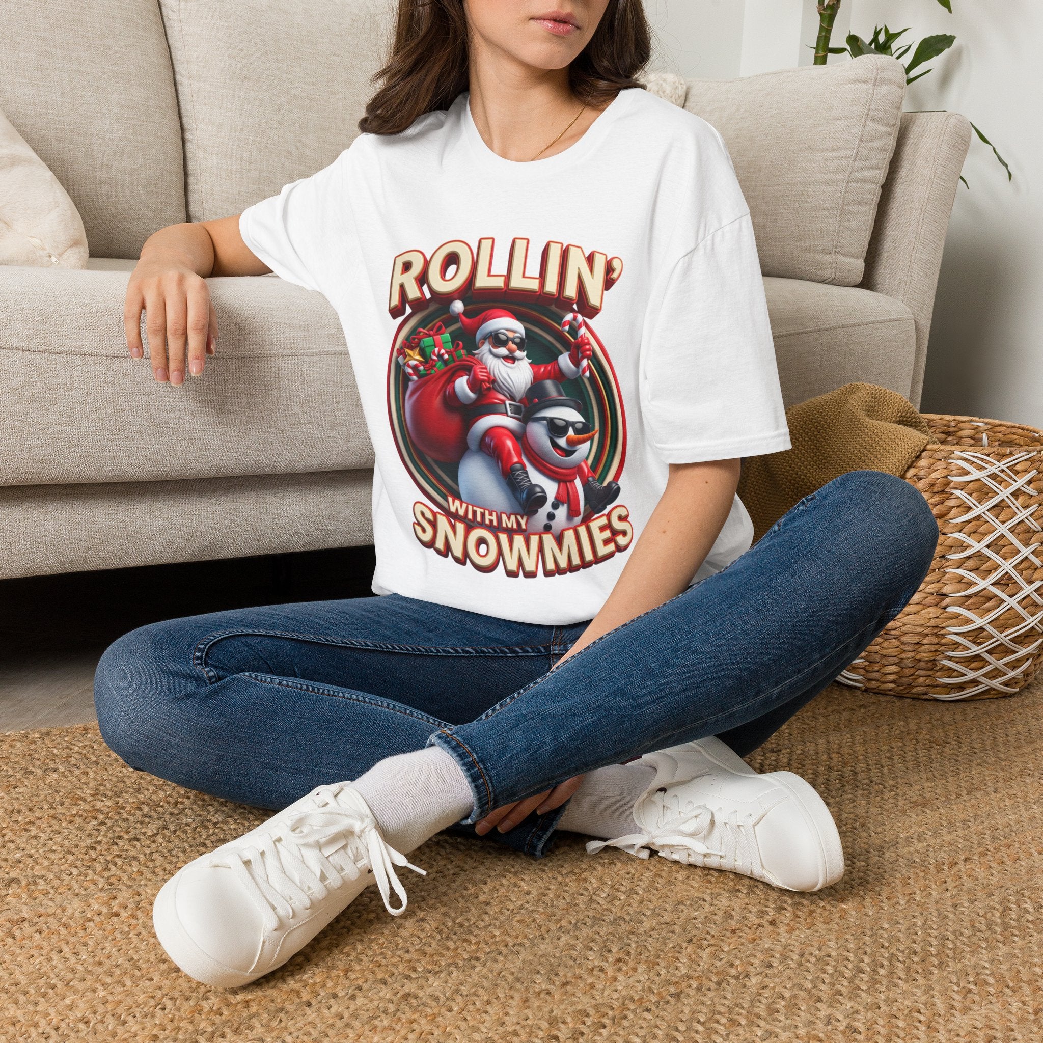 Rollin' with My Snowmies Santa & Snowman t-shirt in White, worn by a woman seated on a rug