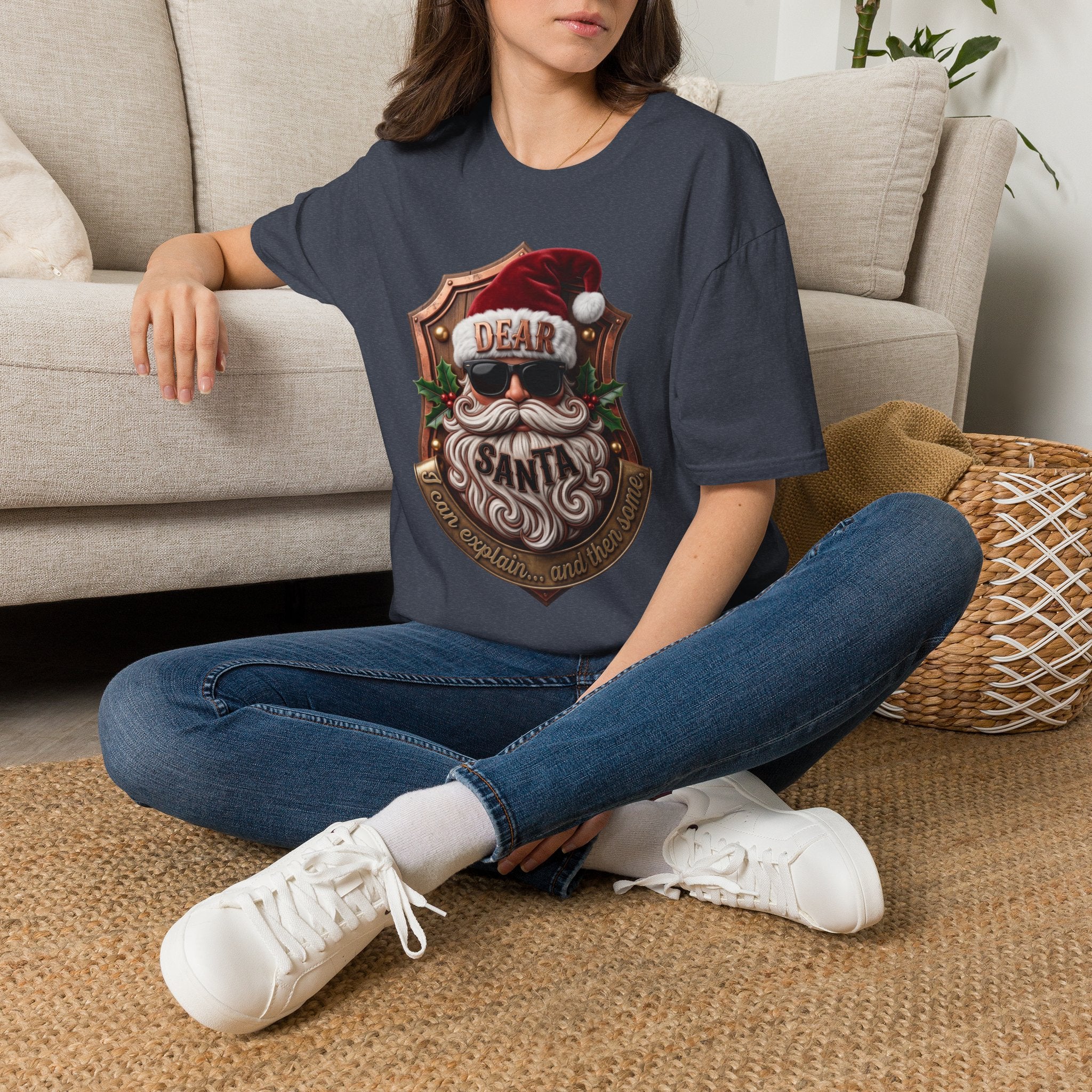 Dear Santa I Can Explain Sunglasses Crest t-shirt in Heather Navy, worn by a woman seated on a rug