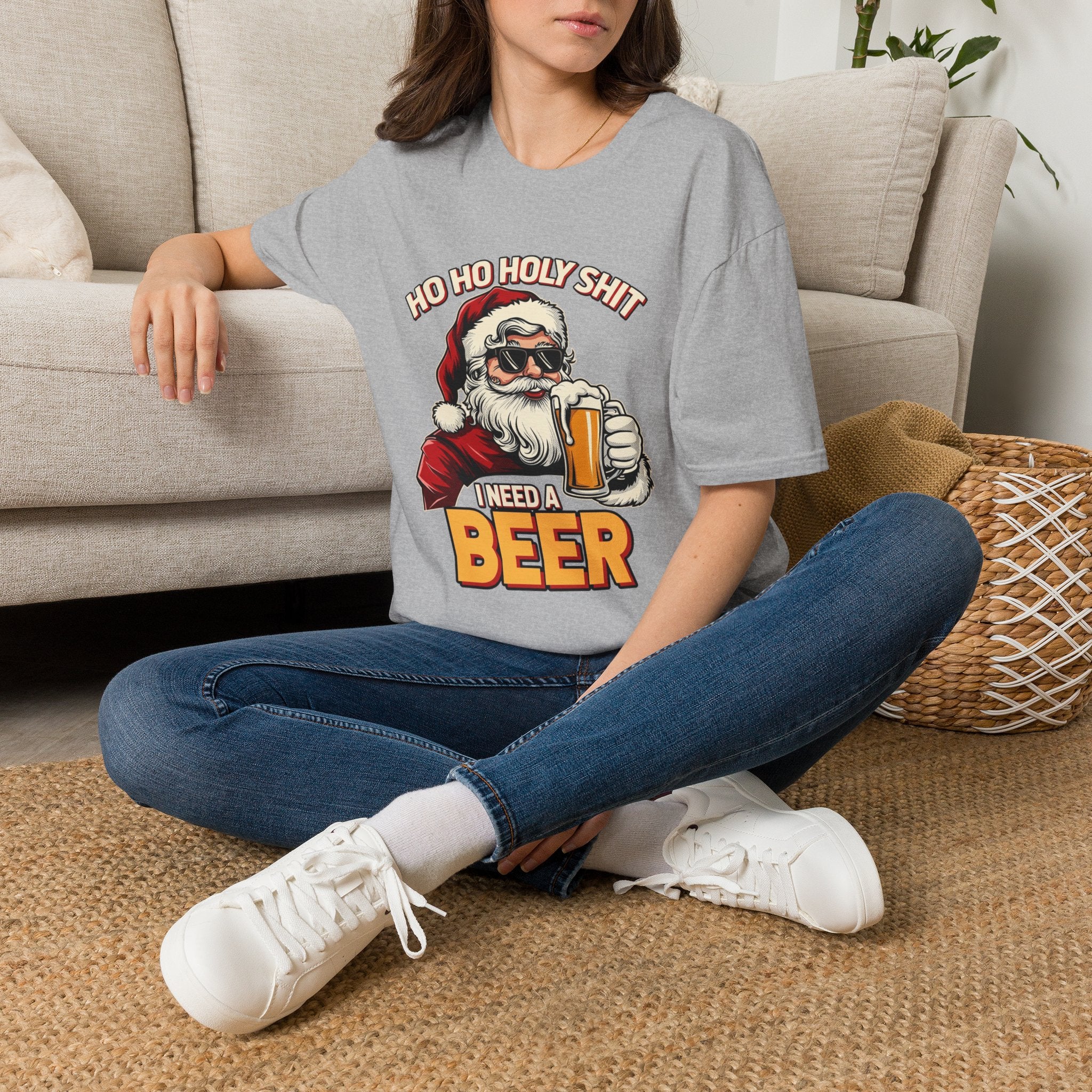 Ho Ho Holy Sh*t I Need a Beer t-shirt in Sport Grey, worn by a woman seated on a rug
