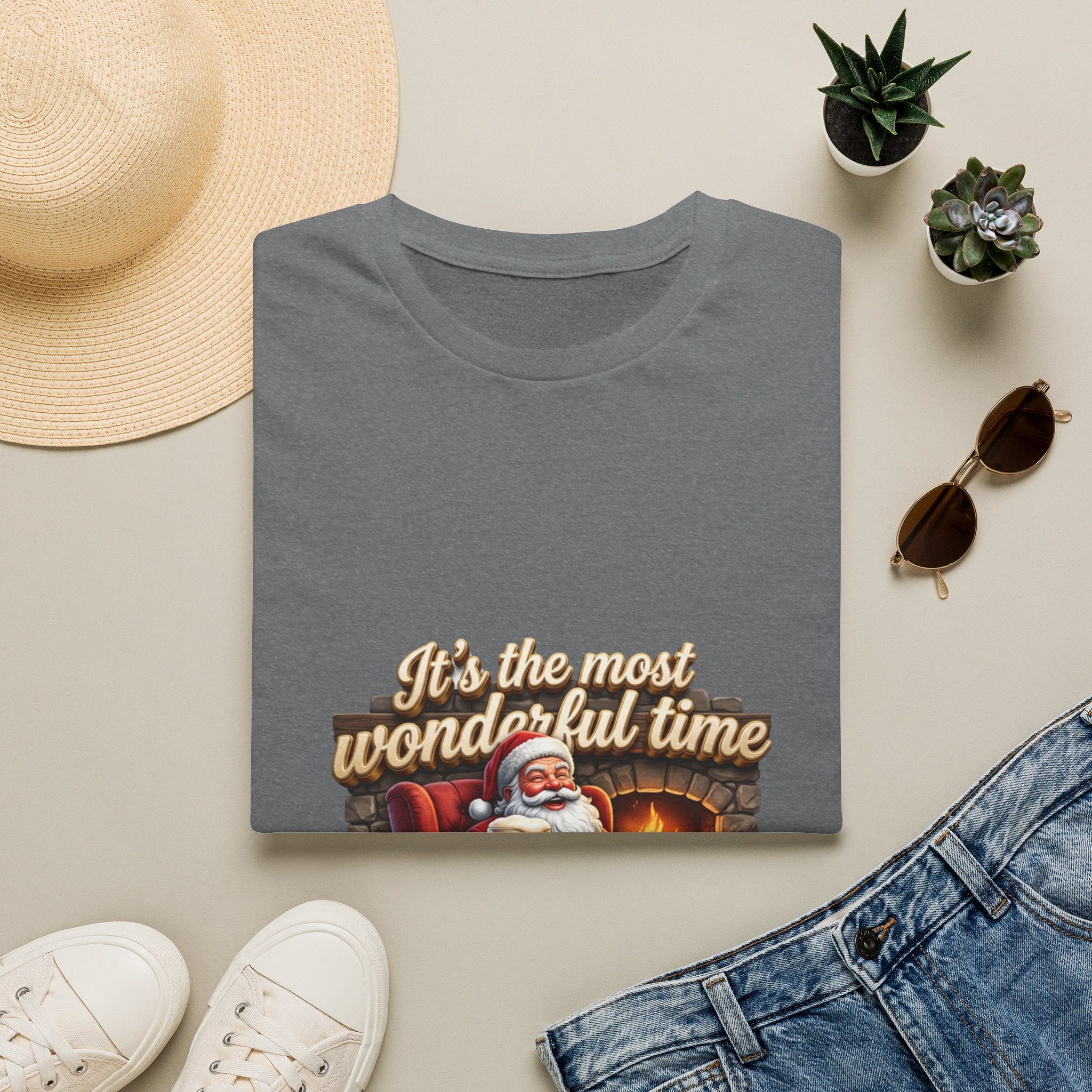 Most Wonderful Time for a Beer Santa print on a Graphite Heather t-shirt, folded beside a straw hat and jeans