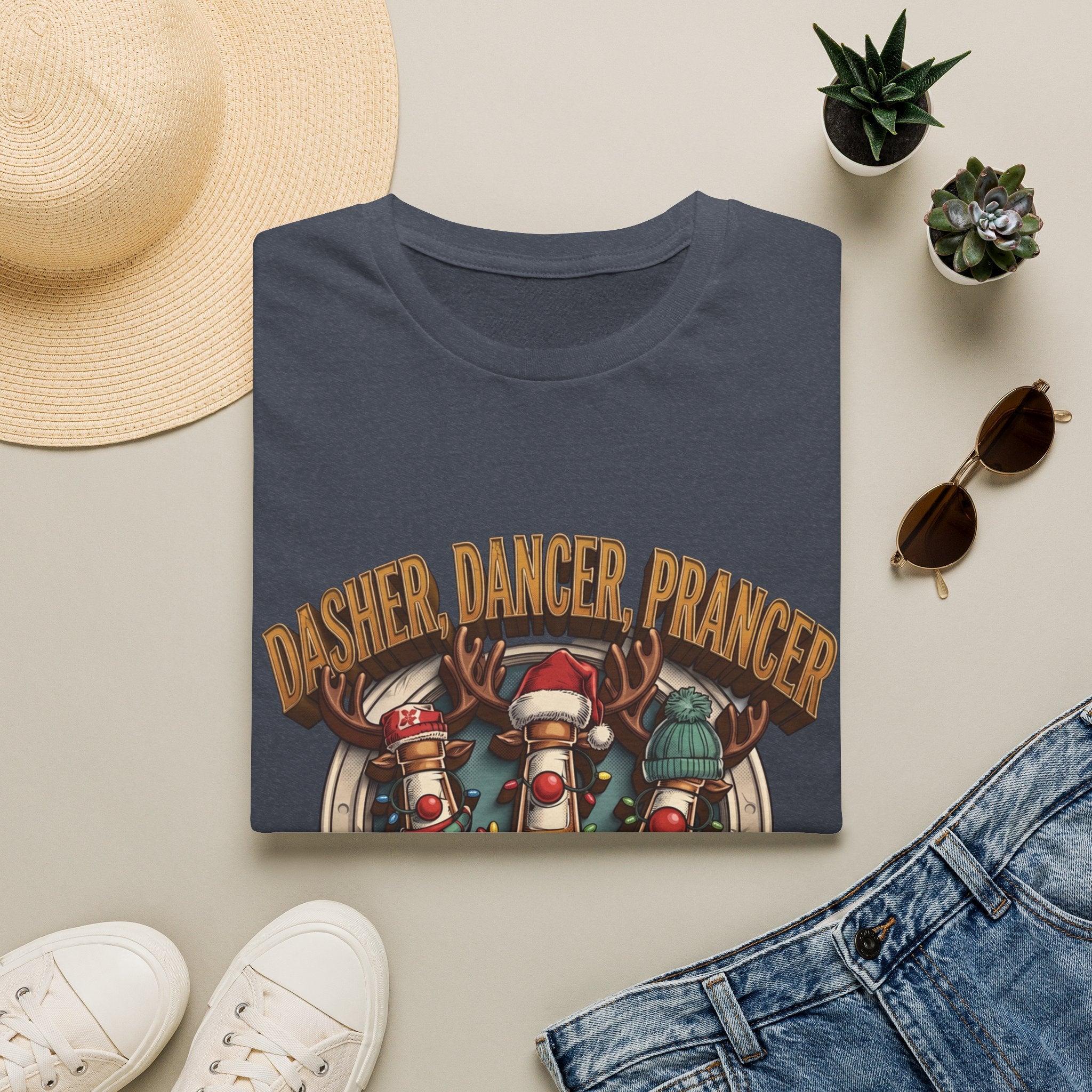 Dasher Dancer Prancer Reinbeer Christmas Beer print on a Heather Navy t-shirt, folded beside a straw hat and jeans
