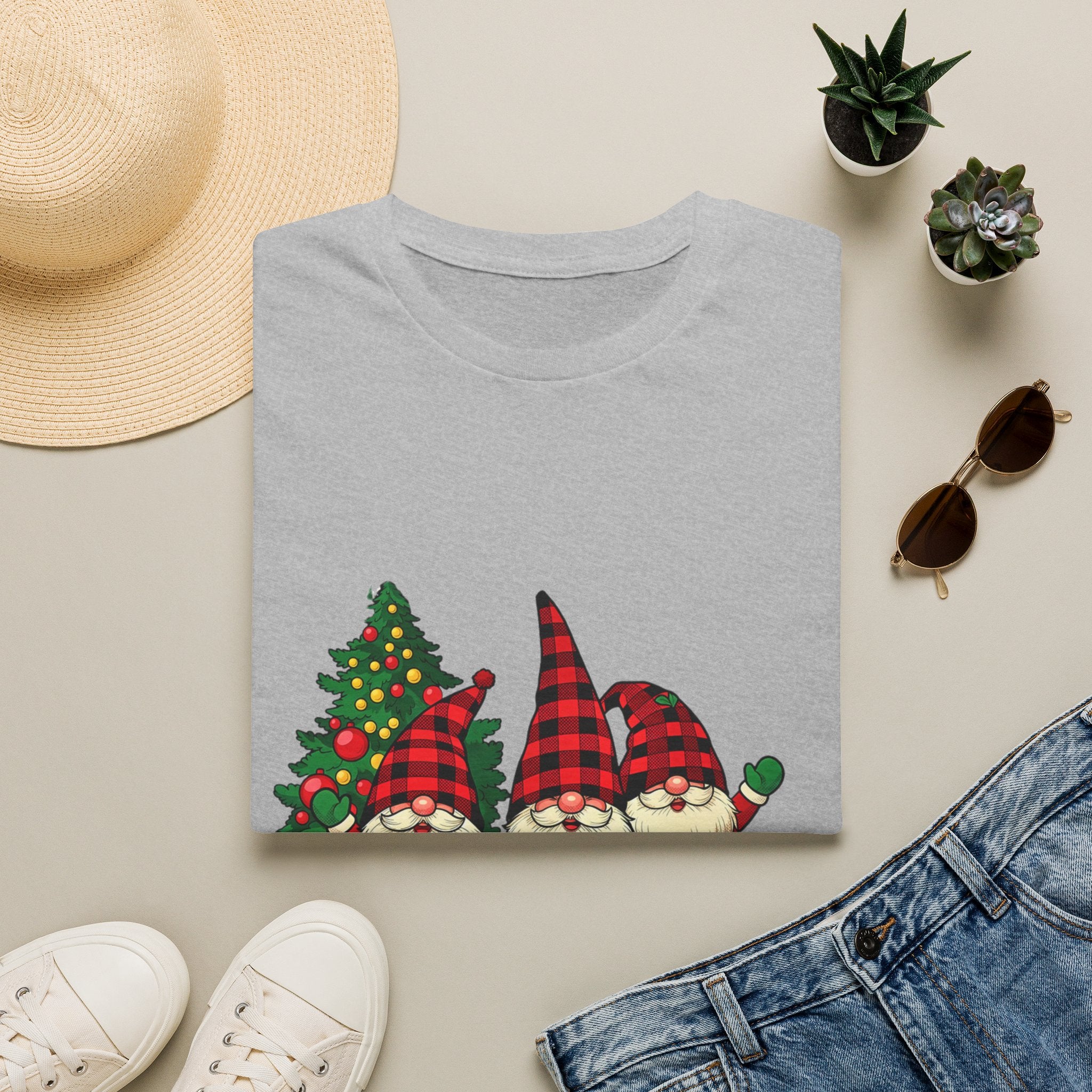 Buffalo Plaid Gnomes Red Truck print on a Sport Grey t-shirt, folded beside a straw hat and jeans