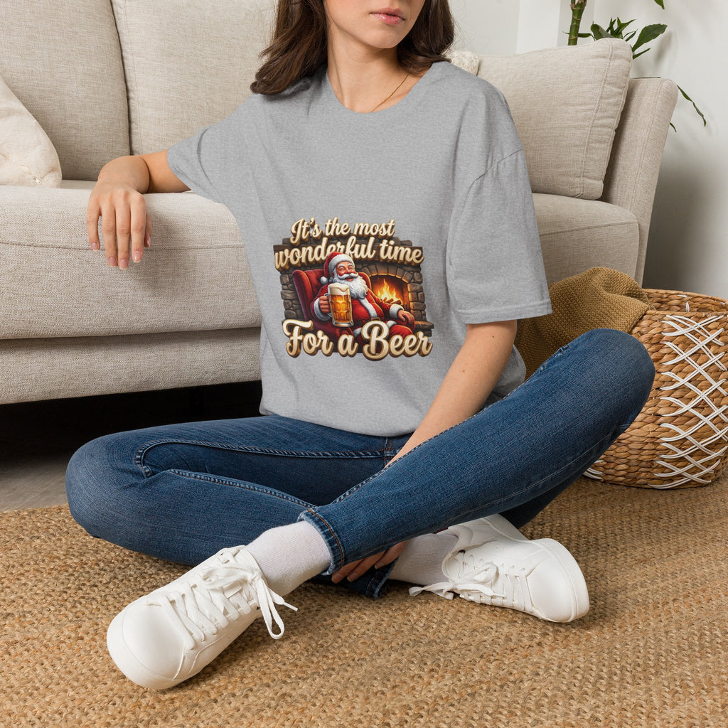 Most Wonderful Time for a Beer Santa t-shirt in Sport Grey, worn by a woman seated on a rug