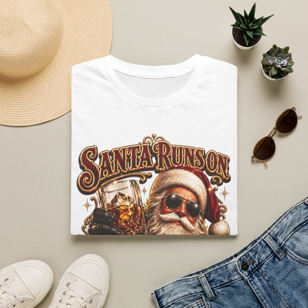 Santa Runs on Bourbon Vintage Whiskey print on a White t-shirt, folded beside a straw hat and jeans