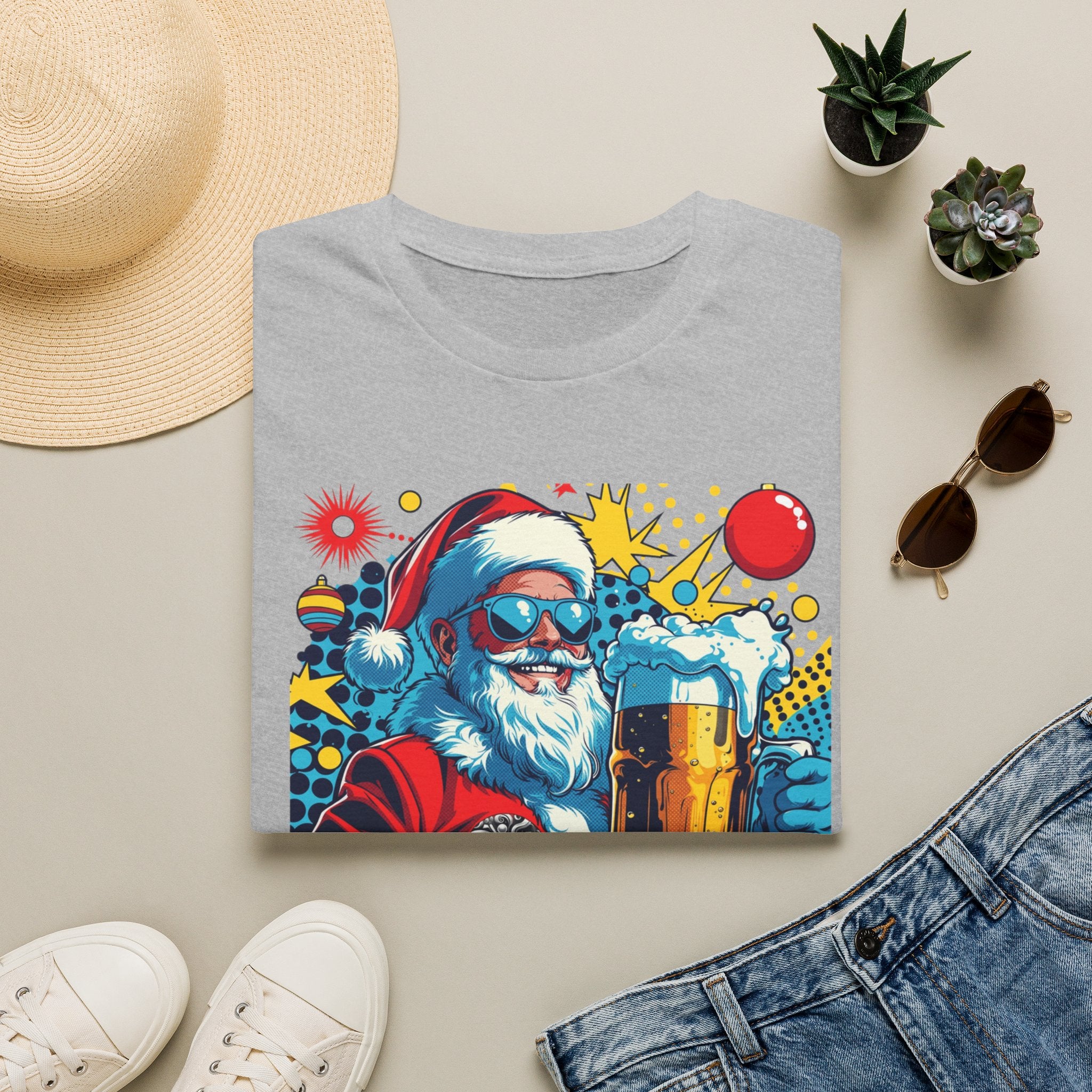 Naughty List Is My People Pop Art Santa Beer print on a Sport Grey t-shirt, folded beside a straw hat and jeans