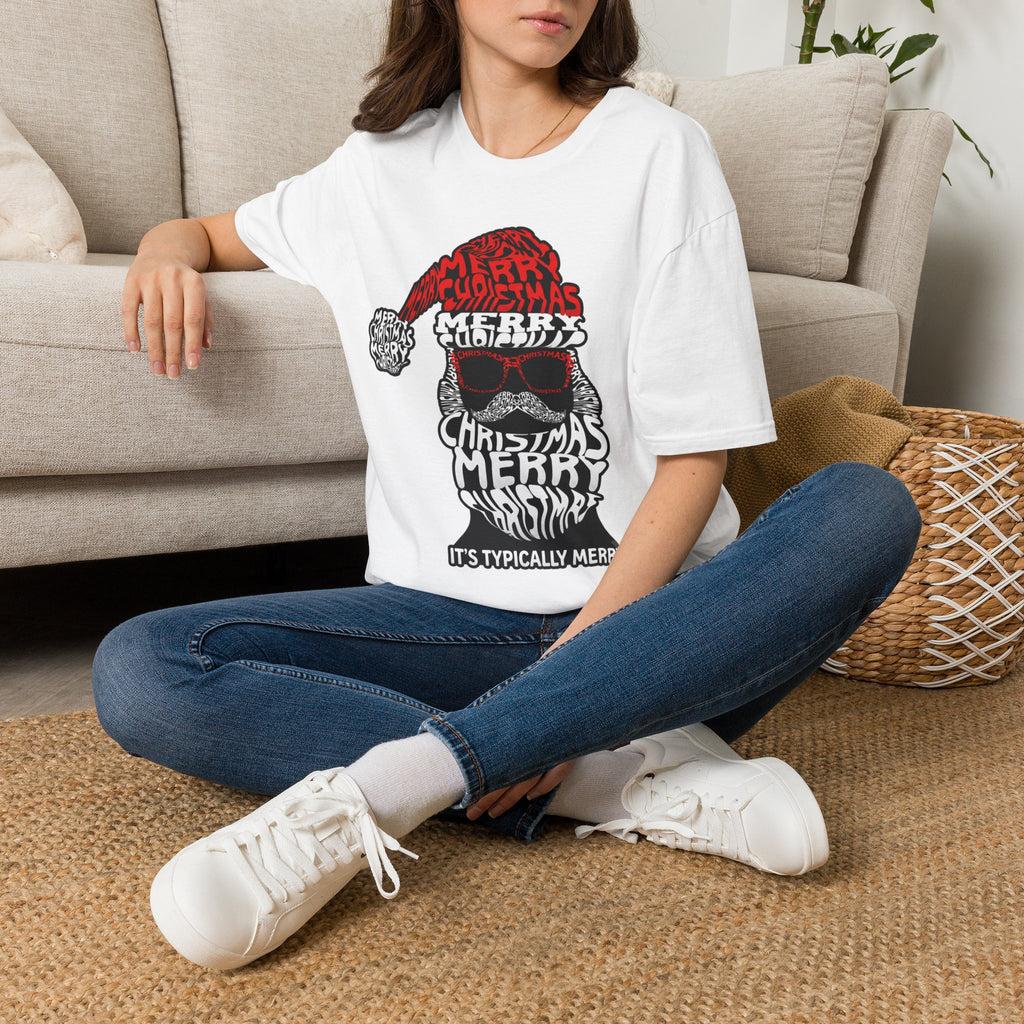 Cool Santa Sunglasses Typography Merry t-shirt in White, worn by a woman seated on a rug