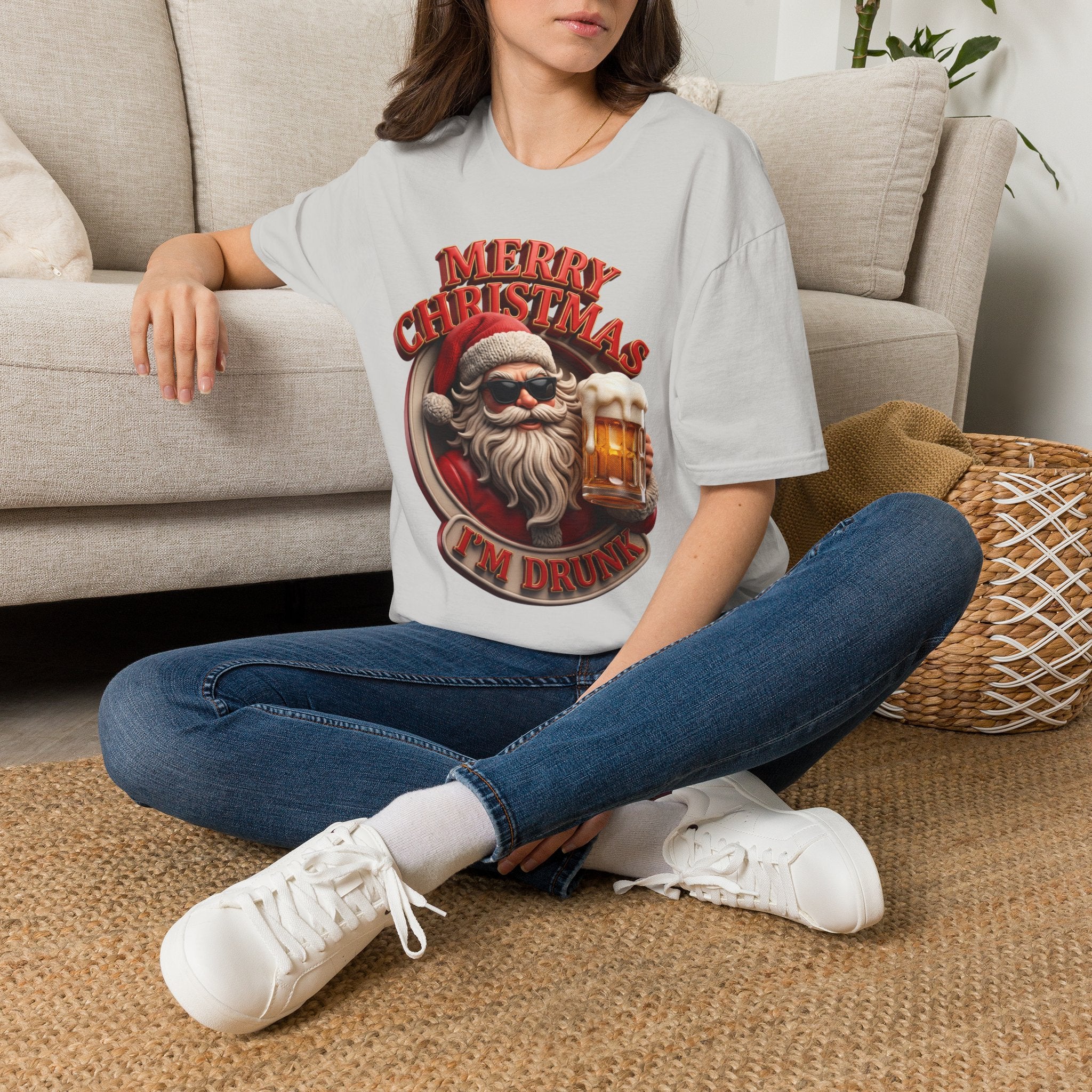 Merry Christmas I'm Drunk Santa t-shirt in Ice Grey, worn by a woman seated on a rug