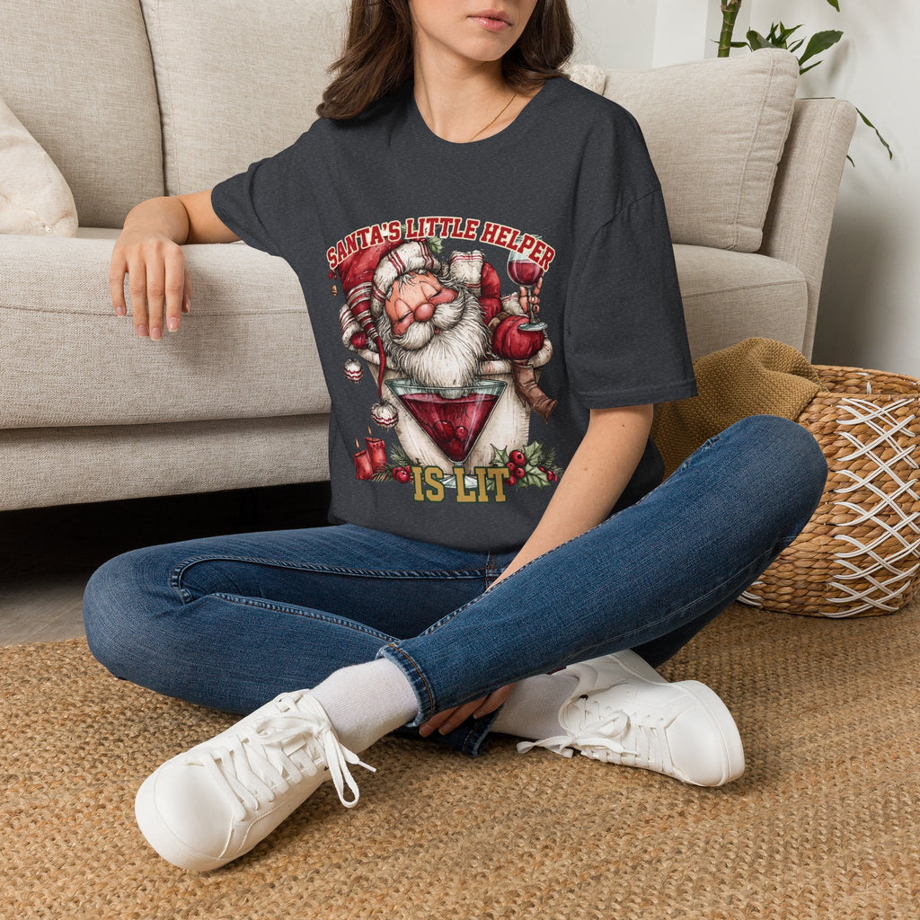 Santa's Little Helper Is Lit Christmas Wine t-shirt in Dark Heather Grey, worn by a woman seated on a rug