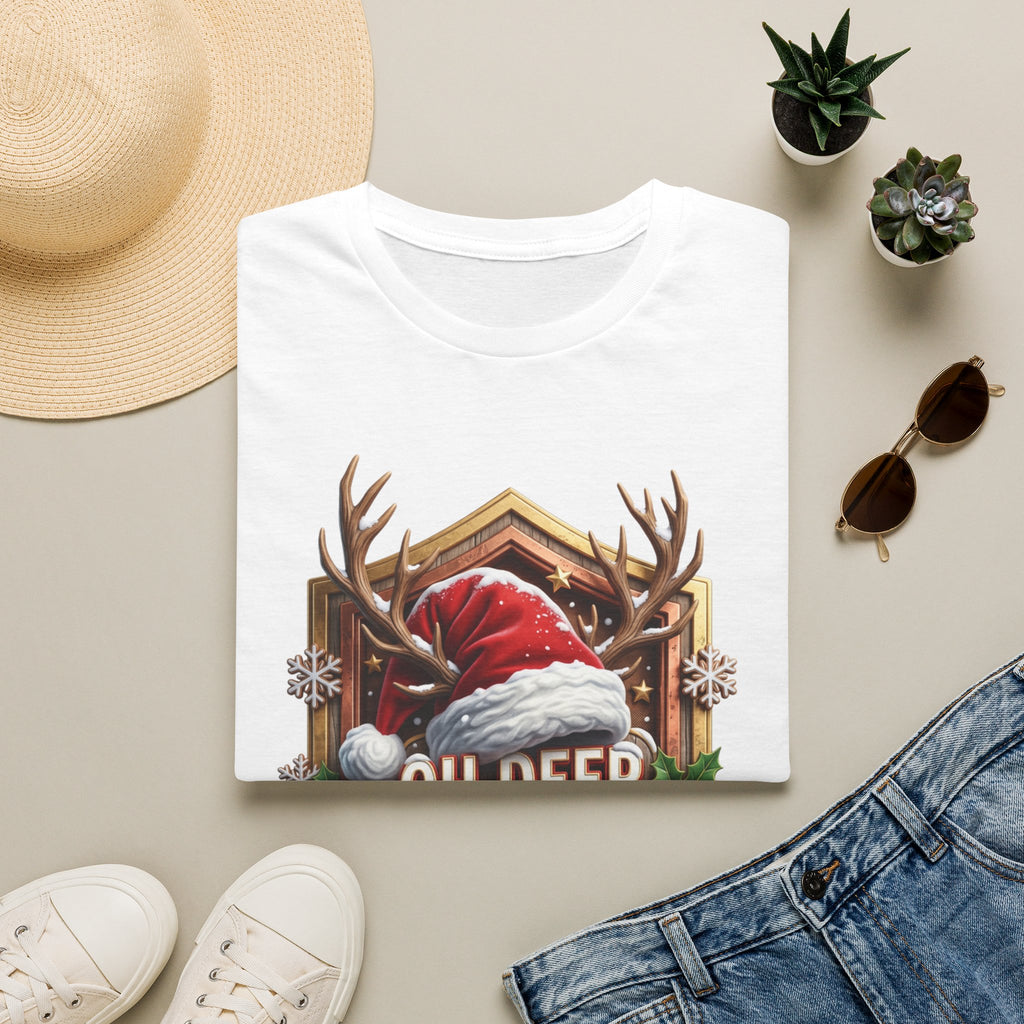 Oh Deer It's Christmas Looks a Lot Like Cocktails print on a White t-shirt, folded beside a straw hat and jeans