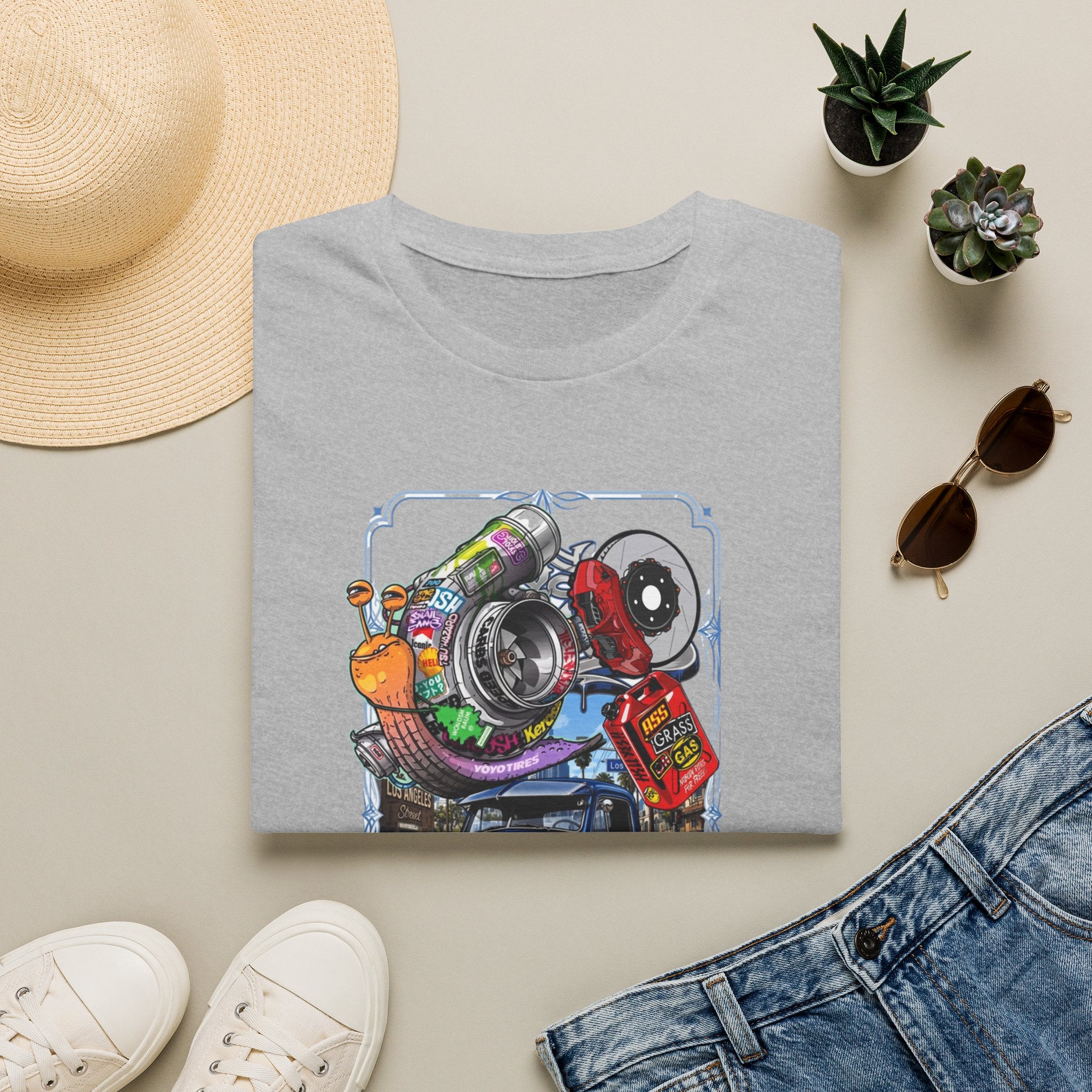 Turbocharged Snail Gearhead Car Parts print on a Sport Grey t-shirt, folded beside a straw hat and jeans