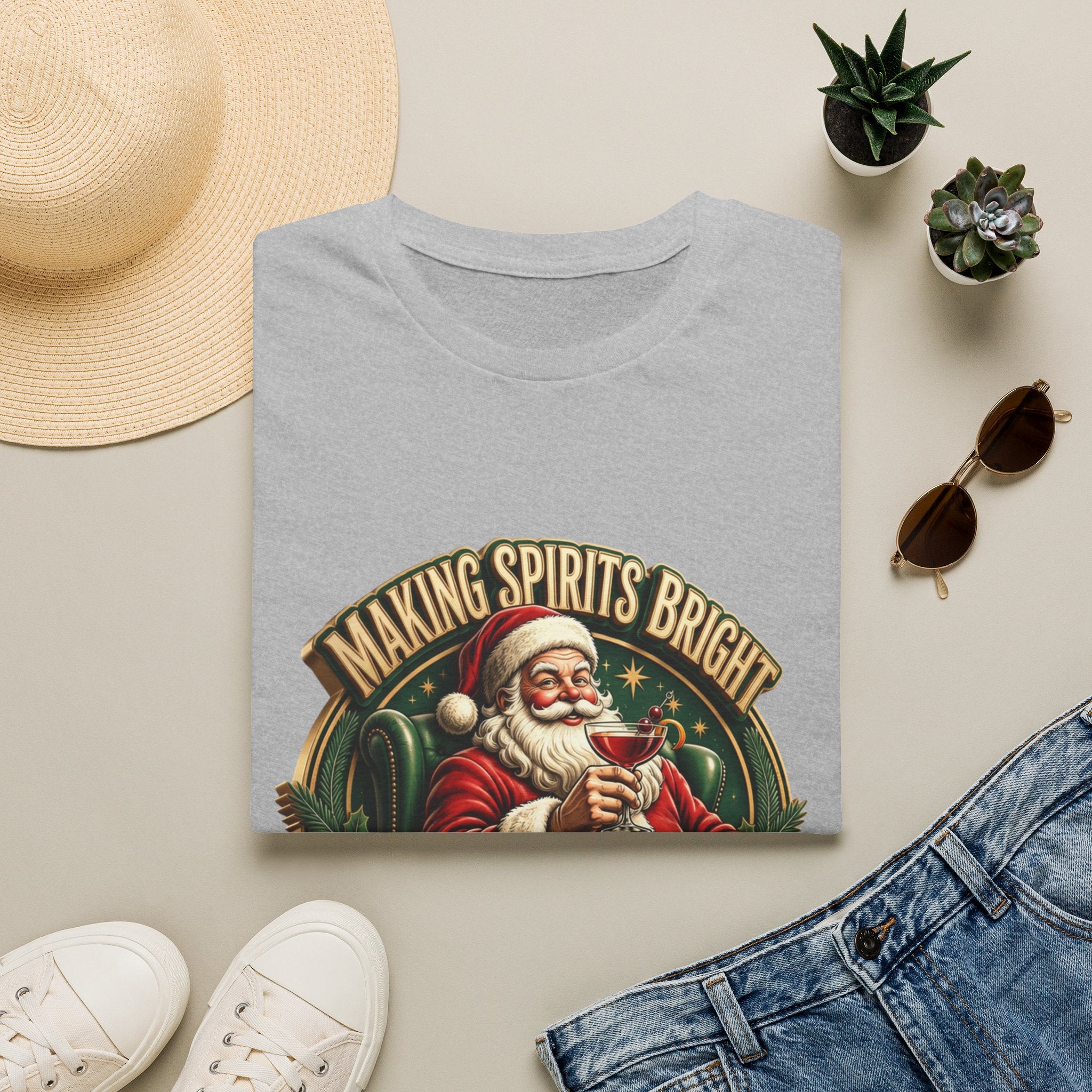 Making Spirits Bright and Stronger Santa print on a Sport Grey t-shirt, folded beside a straw hat and jeans