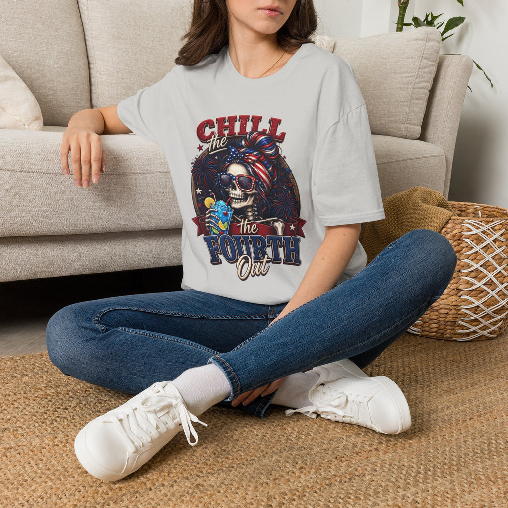 Chill the Fourth Out Patriotic Skeleton 4th of July t-shirt in Ice Grey, worn by a woman seated on a rug