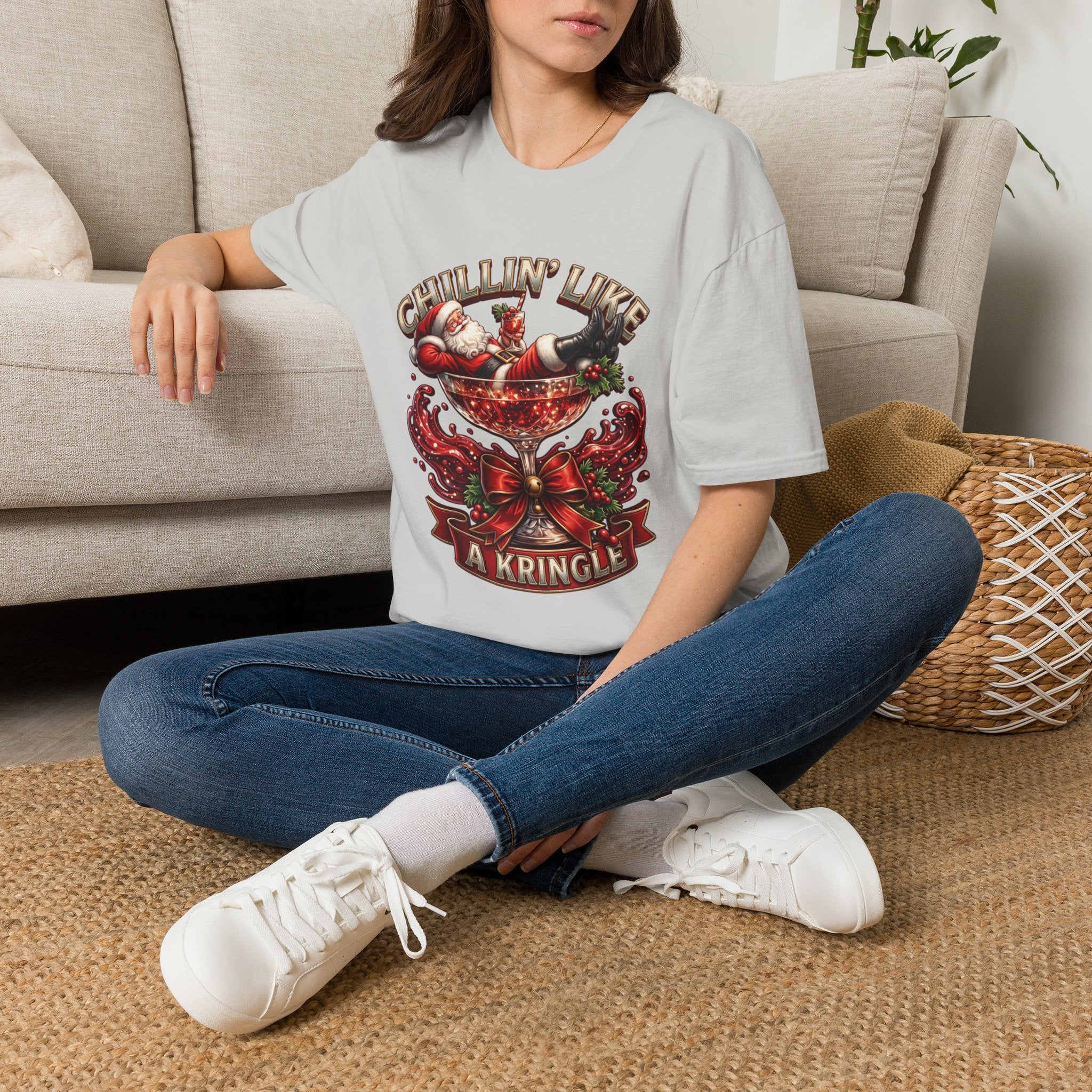 Chillin' Like a Kringle Santa t-shirt in Ice Grey, worn by a woman seated on a rug