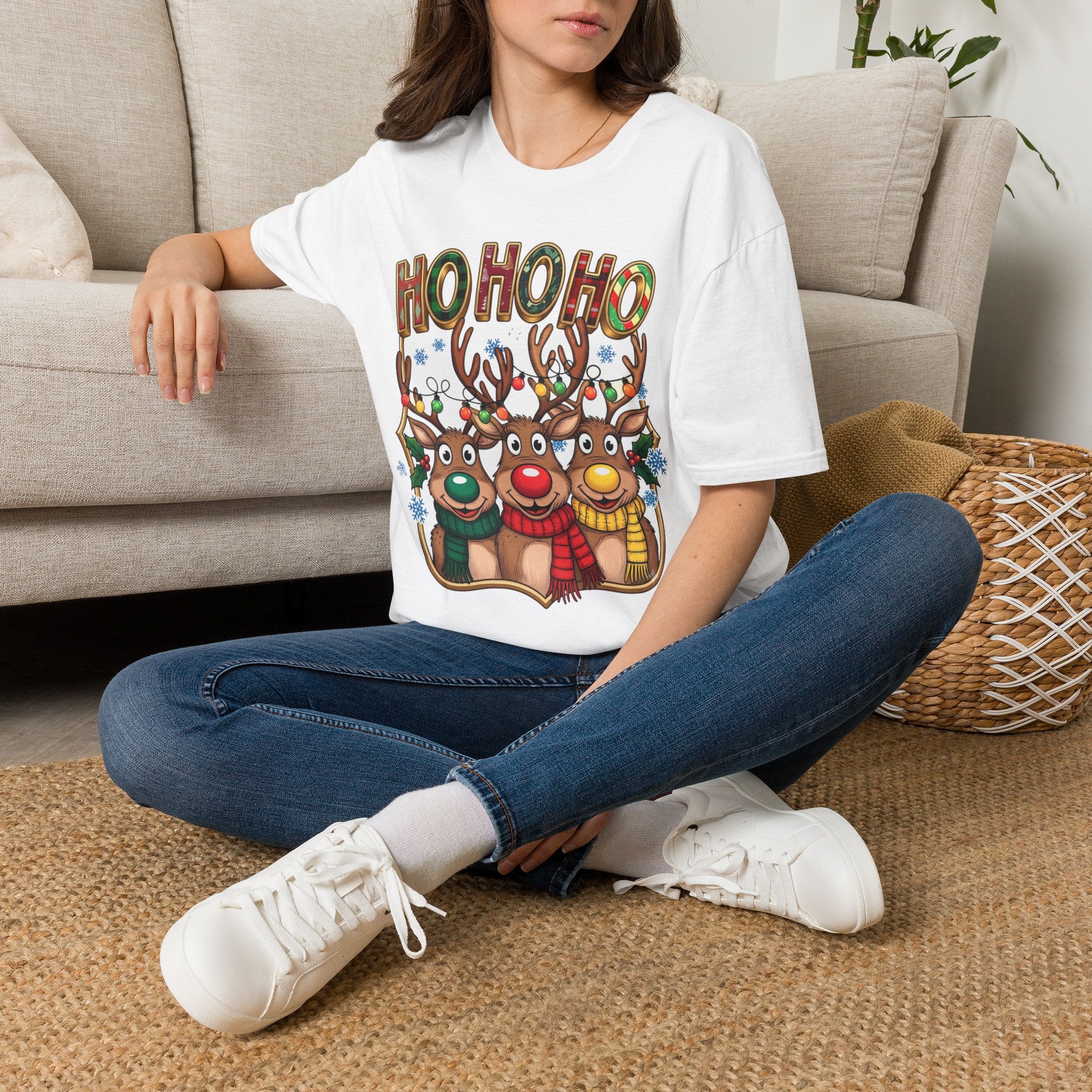 Reindeer Trio Ho Ho Ho Christmas Lights t-shirt in White, worn by a woman seated on a rug