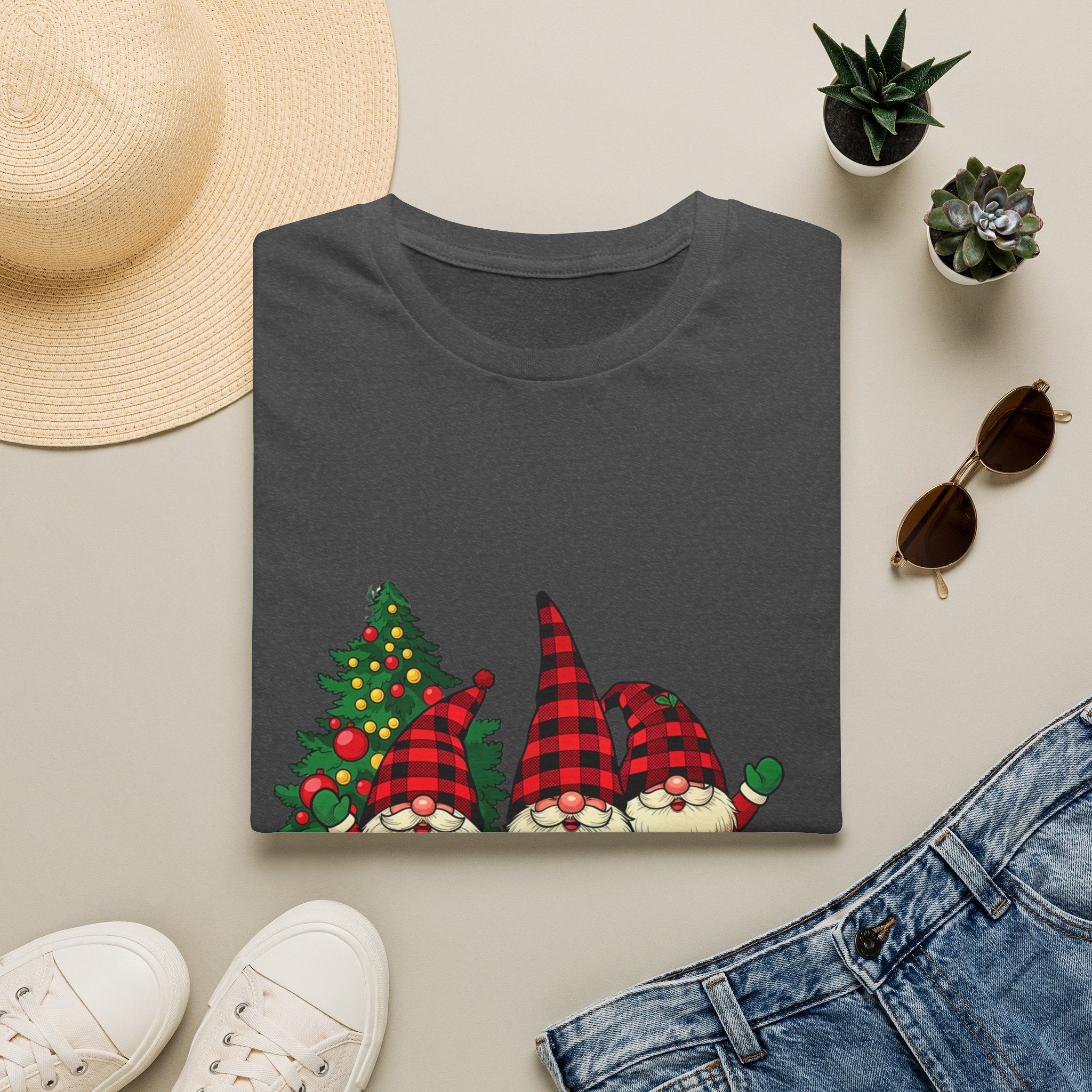 Buffalo Plaid Gnomes Red Truck print on a Dark Heather t-shirt, folded beside a straw hat and jeans