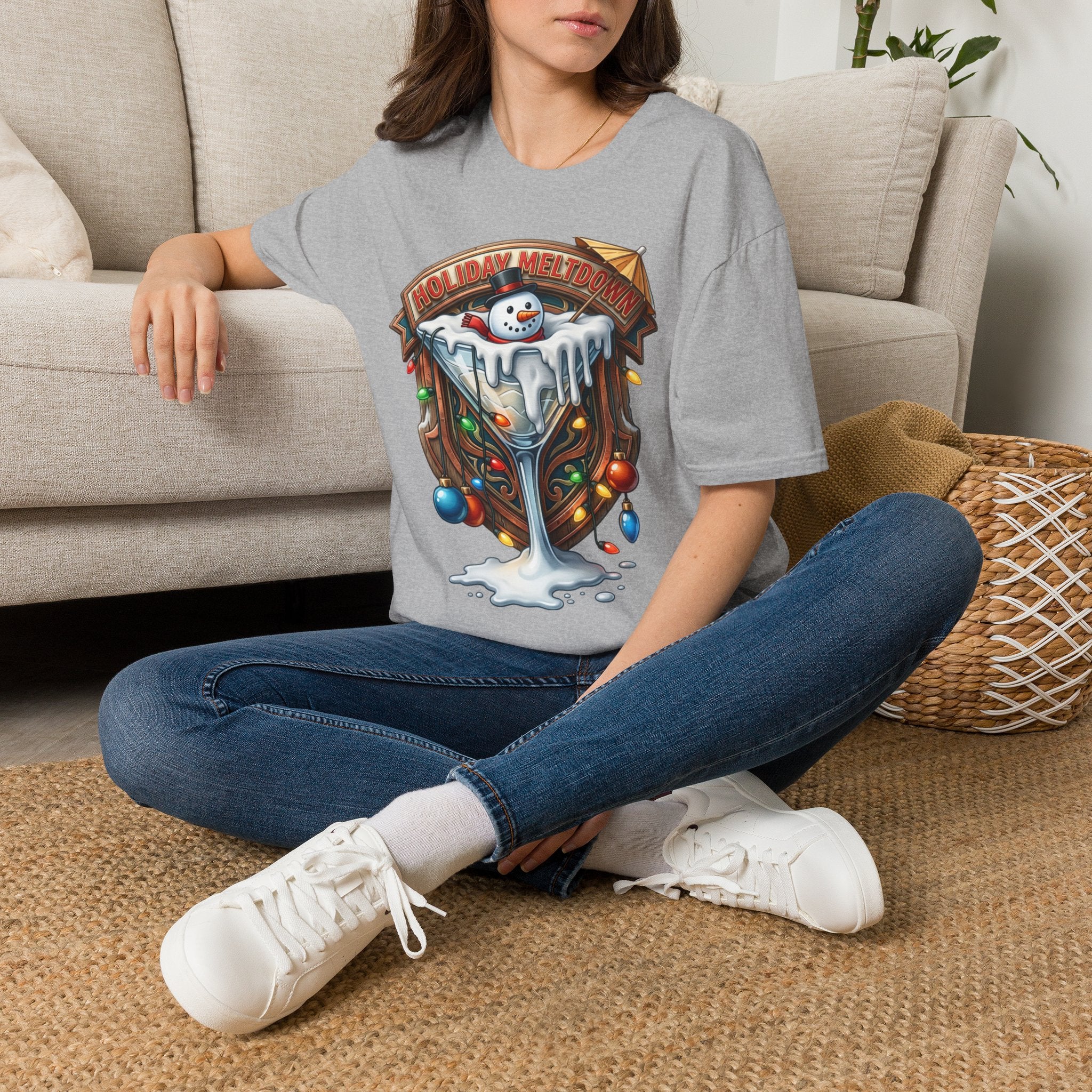Holiday Meltdown Snowman Martini t-shirt in Sport Grey, worn by a woman seated on a rug