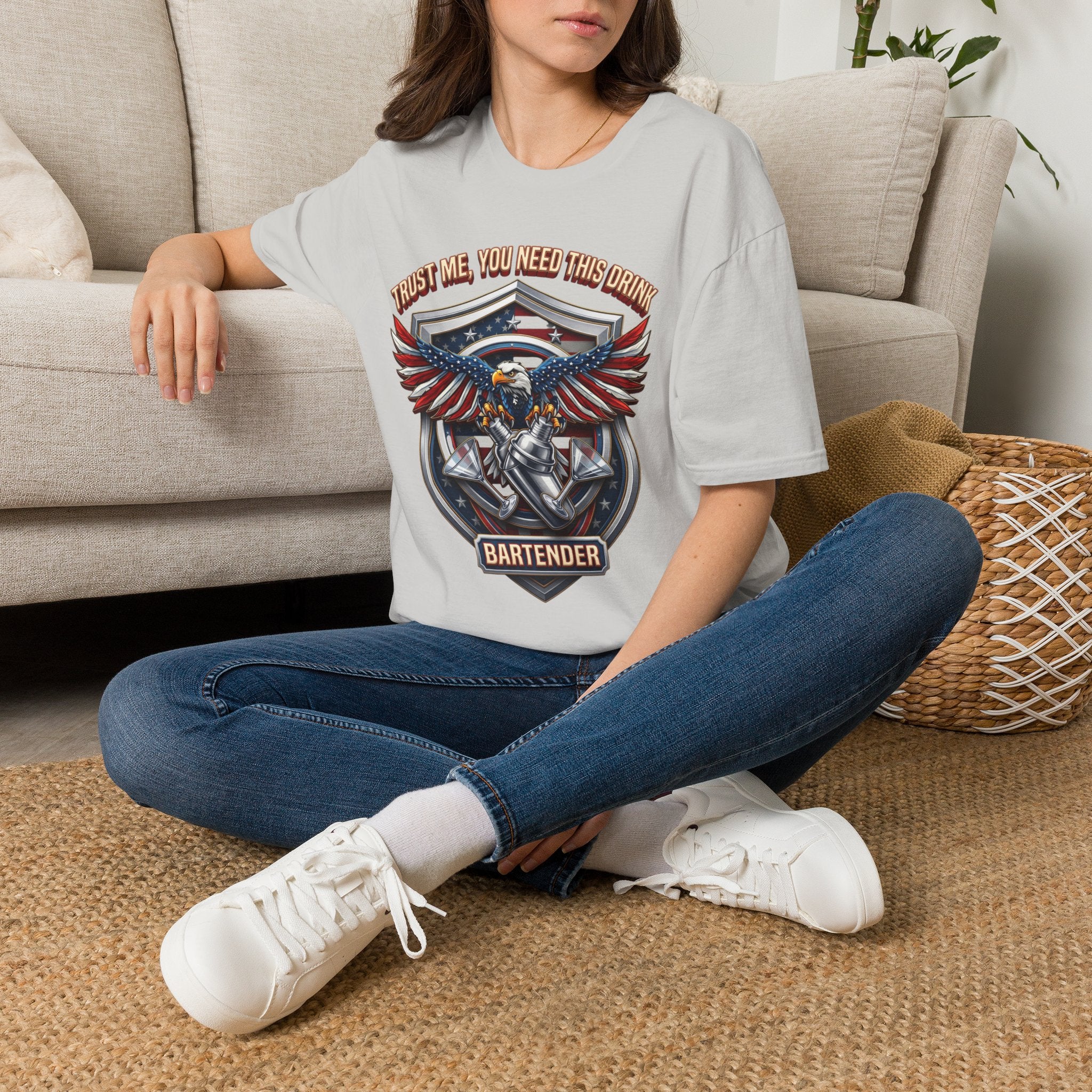 Bartender Eagle Trust Me You Need This Drink t-shirt in Ice Grey, worn by a woman seated on a rug