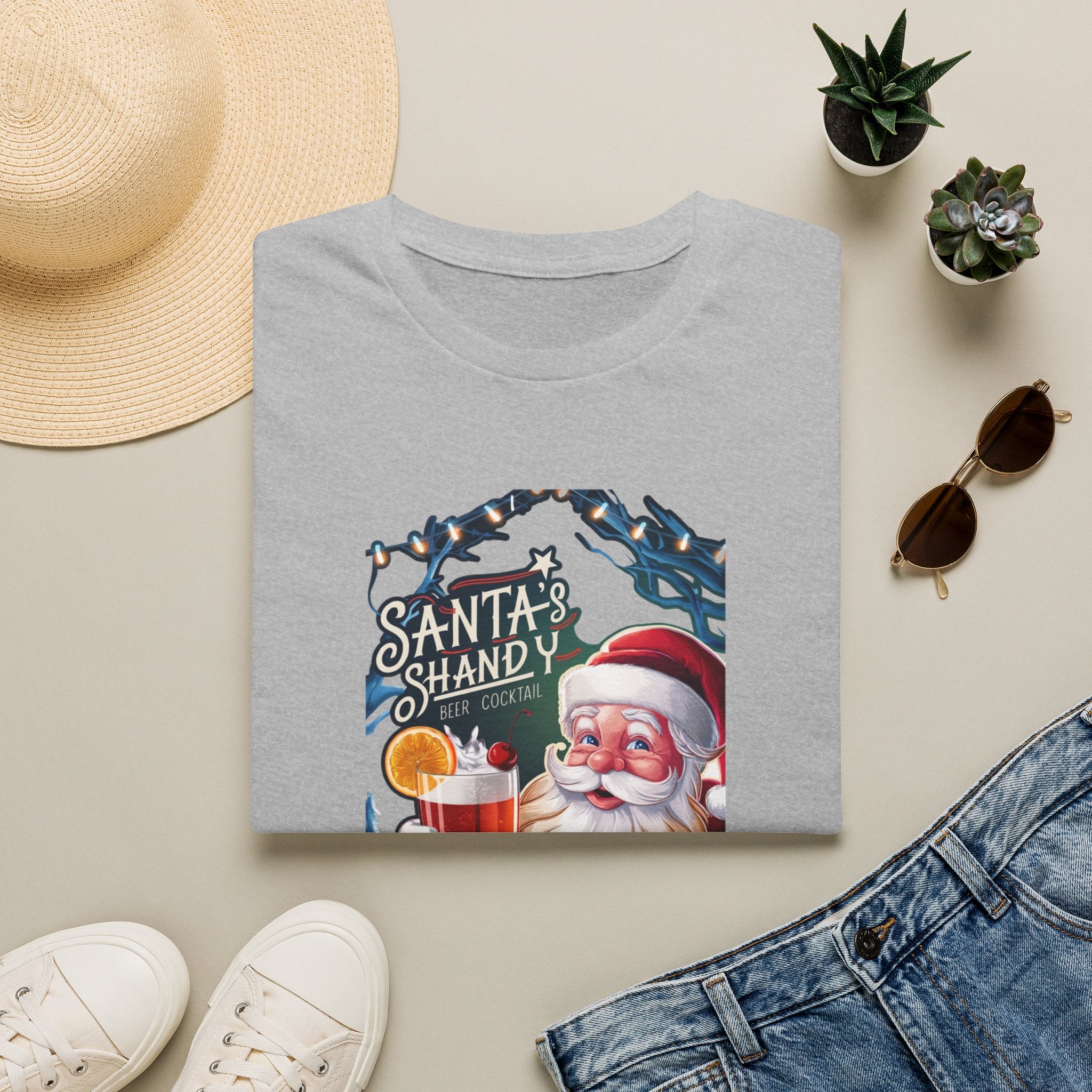 Santa's Shandy Beer Cocktail print on a Sport Grey t-shirt, folded beside a straw hat and jeans
