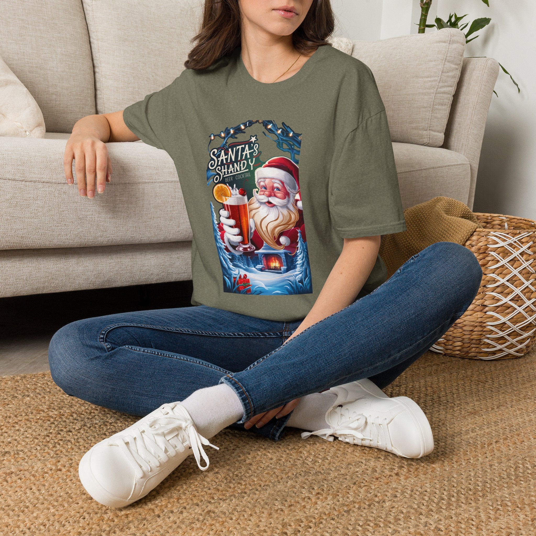 Santa's Shandy Beer Cocktail t-shirt in Heather Military Green, worn by a woman seated on a rug