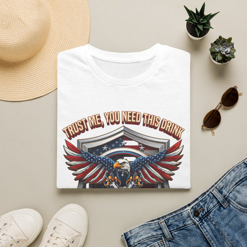 Bartender Eagle Trust Me You Need This Drink print on a White t-shirt, folded beside a straw hat and jeans