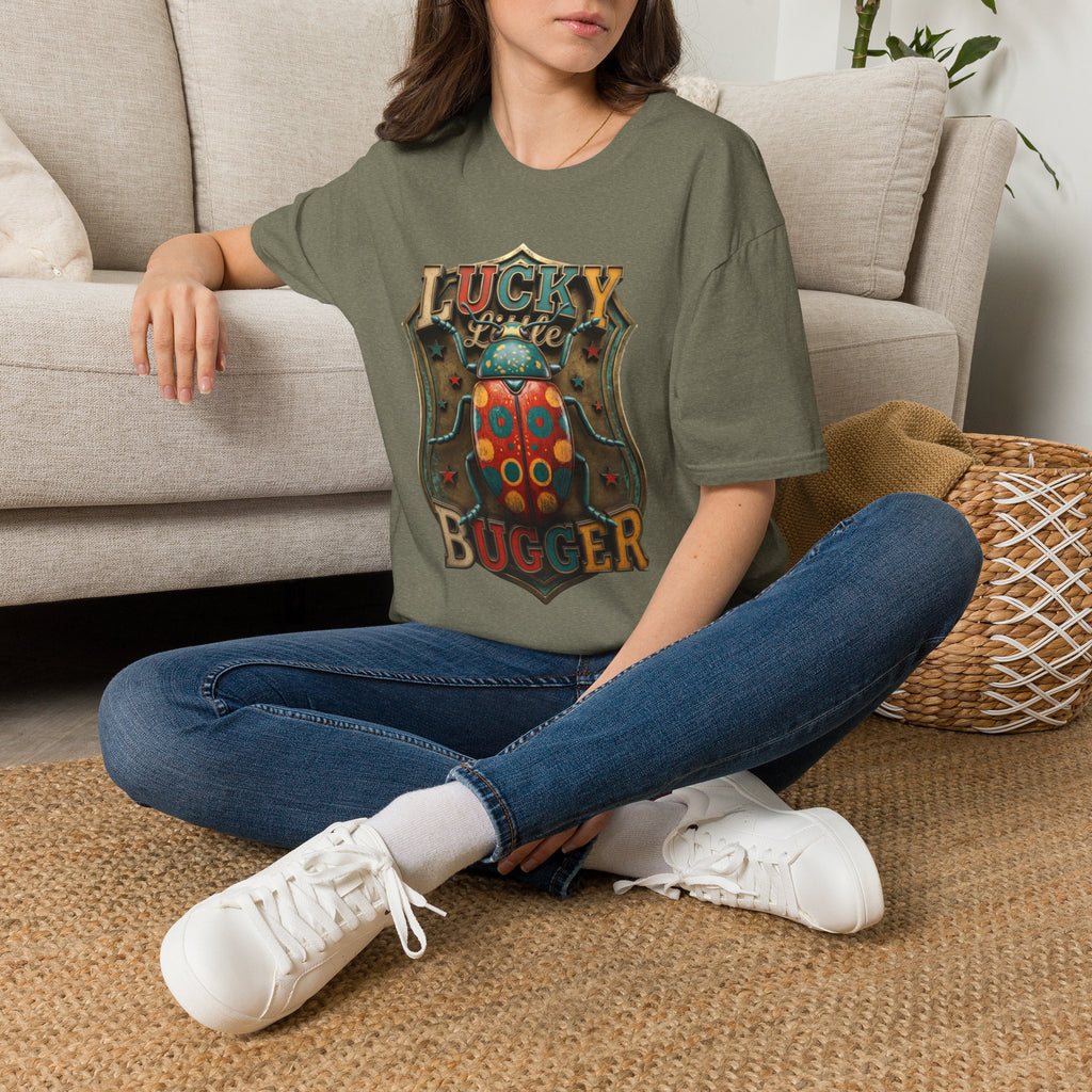 Lucky Little Bugger Vintage Beetle t-shirt in Heather Military Green, worn by a woman seated on a rug
