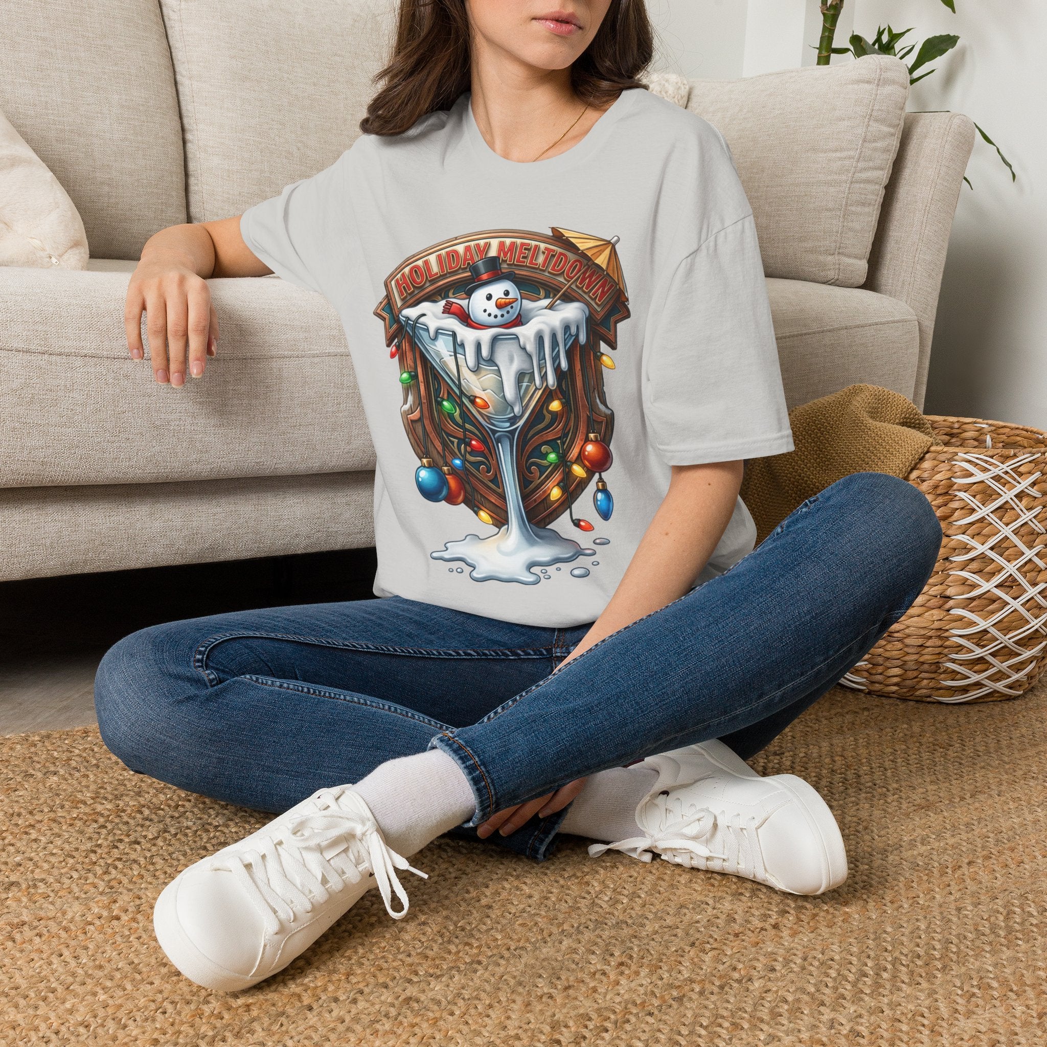 Holiday Meltdown Snowman Martini t-shirt in Ice Grey, worn by a woman seated on a rug