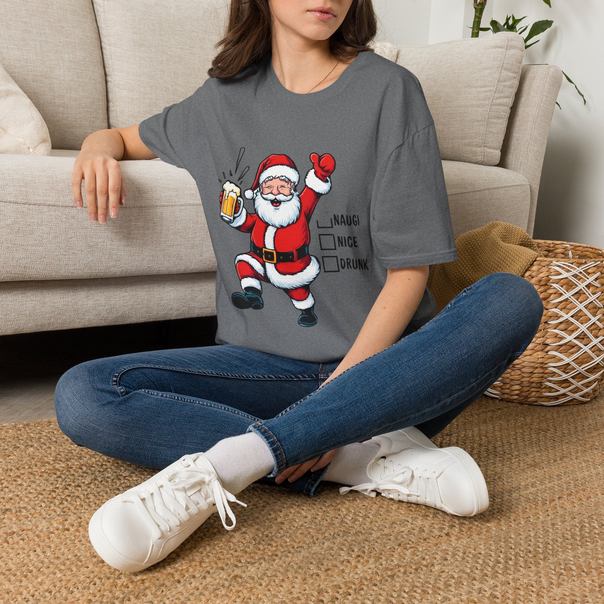 Naughty Nice Drunk Santa Beer Checklist t-shirt in Graphite Heather, worn by a woman seated on a rug