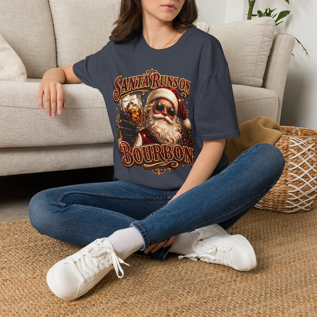 Santa Runs on Bourbon Vintage Whiskey t-shirt in Heather Navy, worn by a woman seated on a rug
