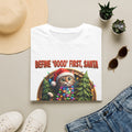 Define Good First Santa Funny Christmas Cat print on a White t-shirt, folded beside a straw hat and jeans