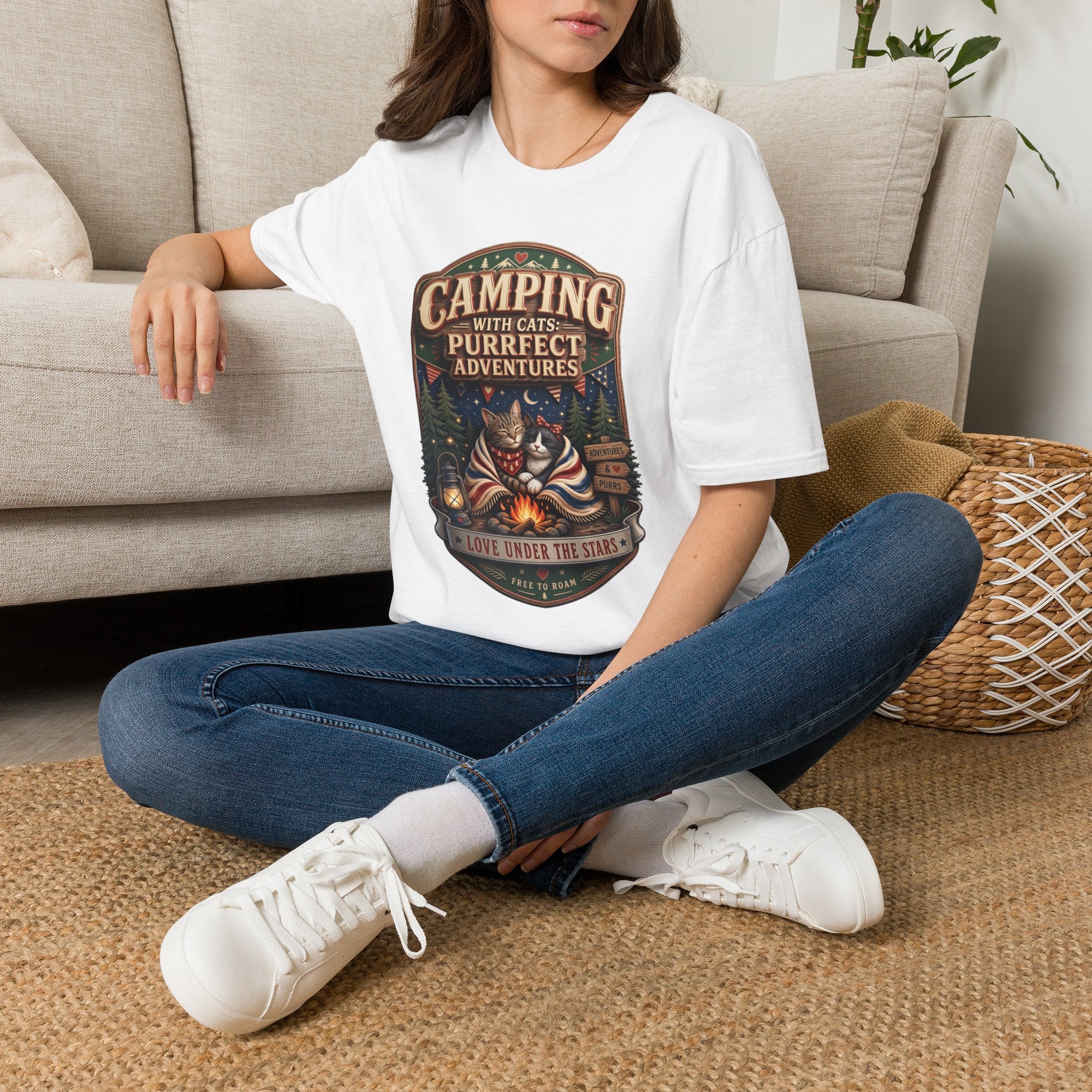Camping With Cats Purrfect Adventures t-shirt in White, worn by a woman seated on a rug