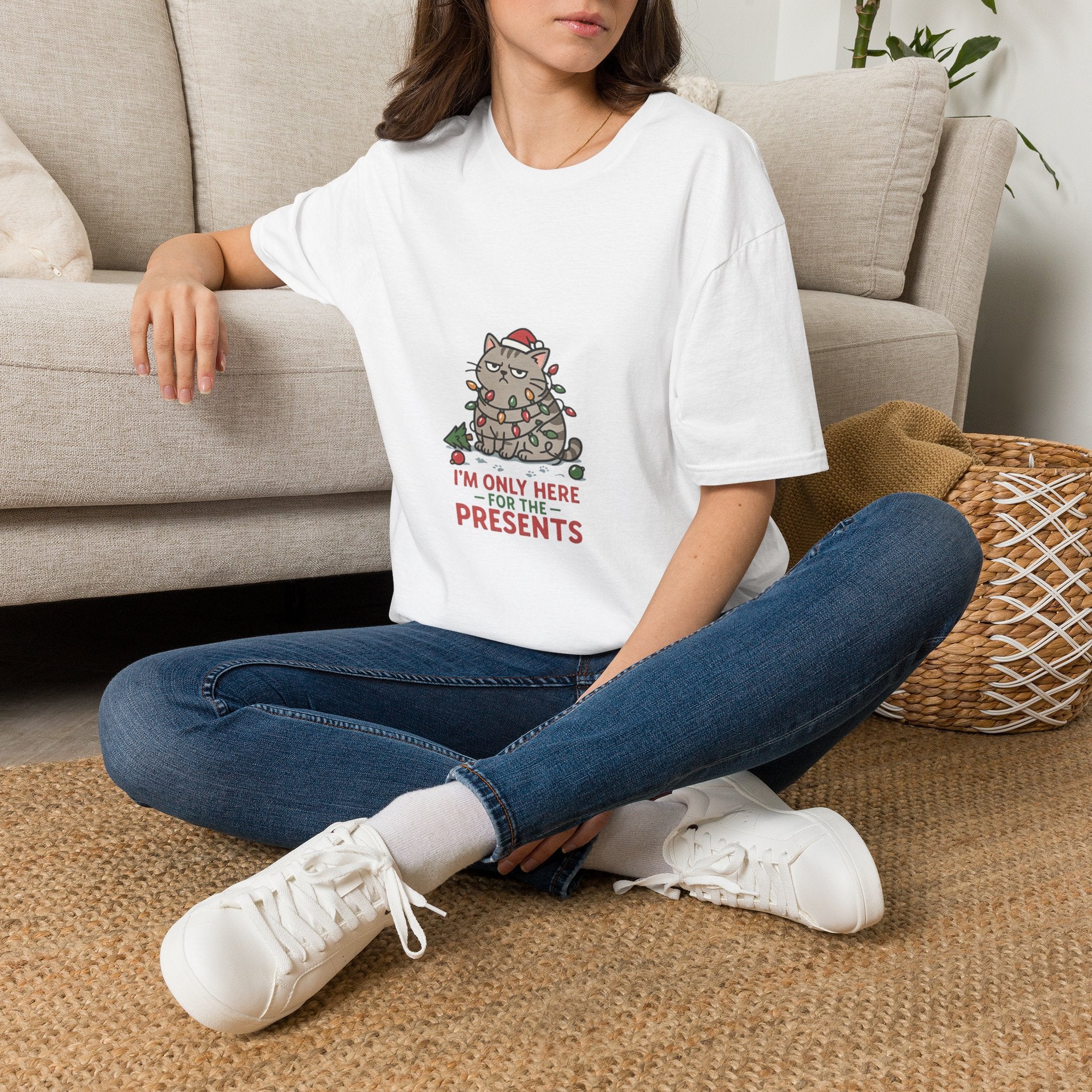 Funny Cat I'm Only Here for the Presents t-shirt in White, worn by a woman seated on a rug