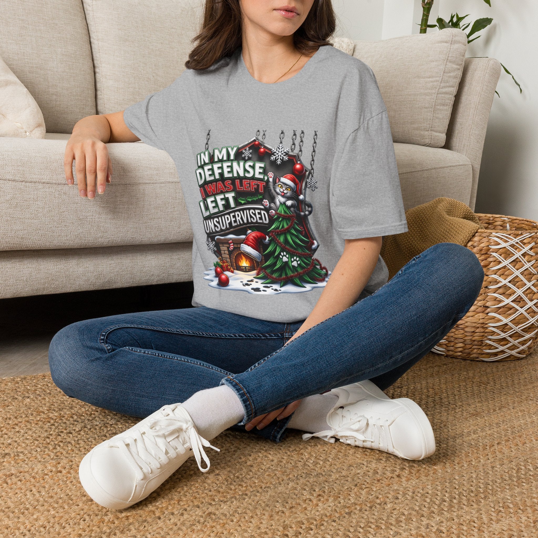 Cat In My Defense Left Unsupervised t-shirt in Sport Grey, worn by a woman seated on a rug