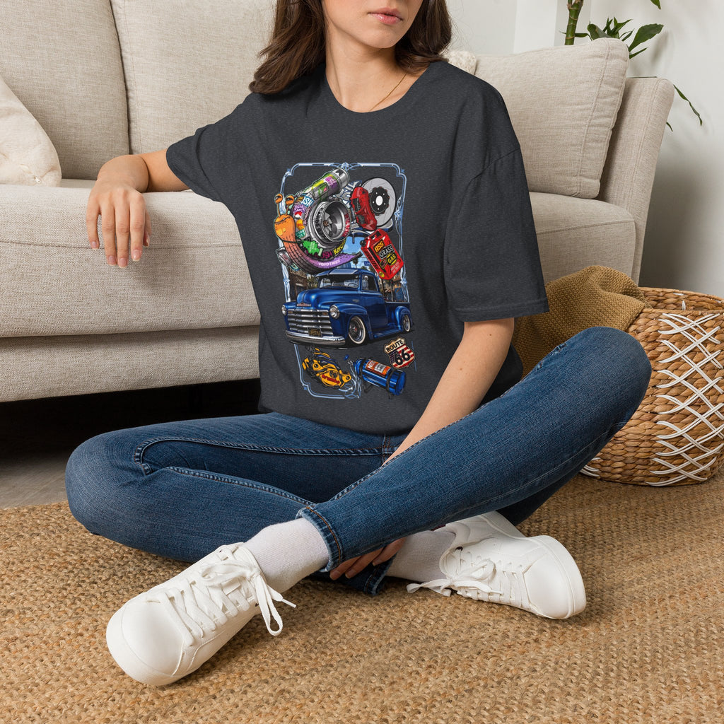 Turbocharged Snail Gearhead Car Parts t-shirt in Dark Heather Grey, worn by a woman seated on a rug