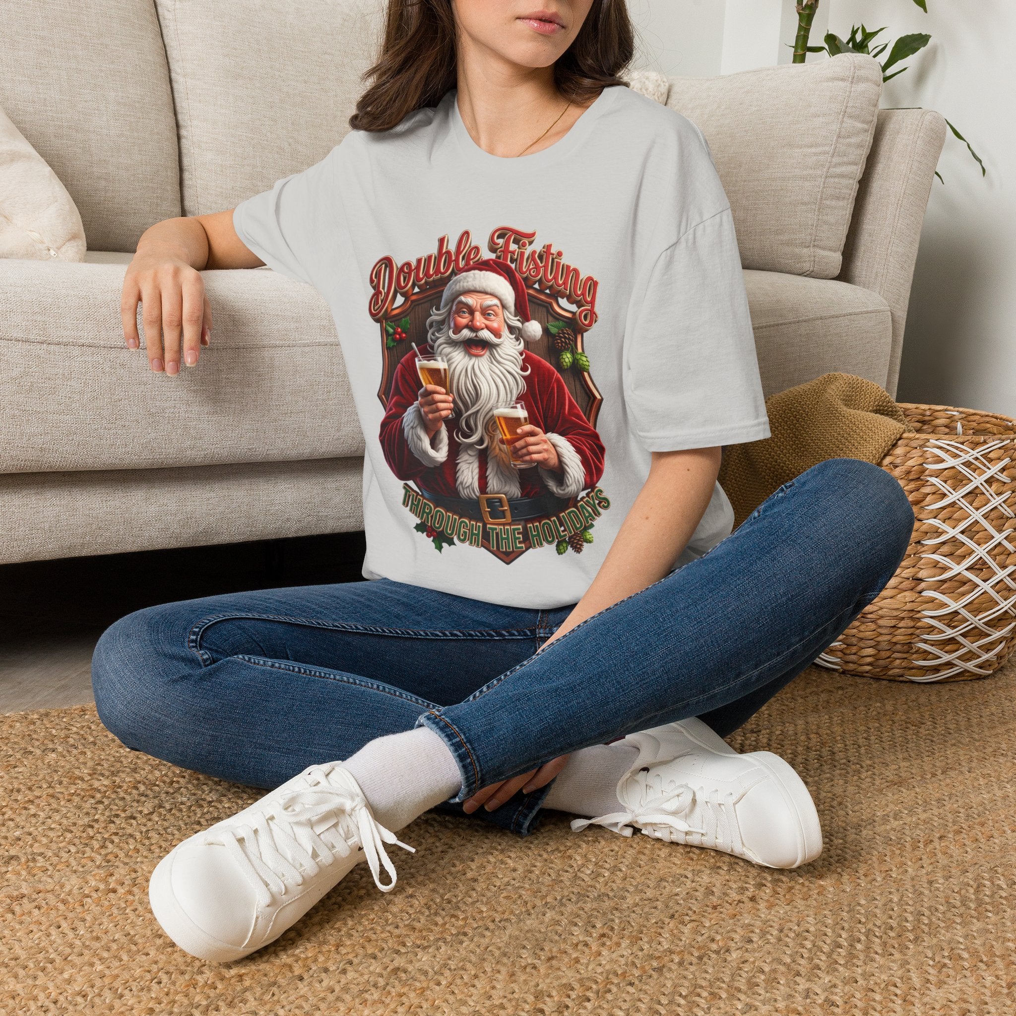 Santa Beer in Each Hand Funny t-shirt in Ice Grey, worn by a woman seated on a rug