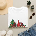 Buffalo Plaid Gnomes Red Truck print on a White t-shirt, folded beside a straw hat and jeans