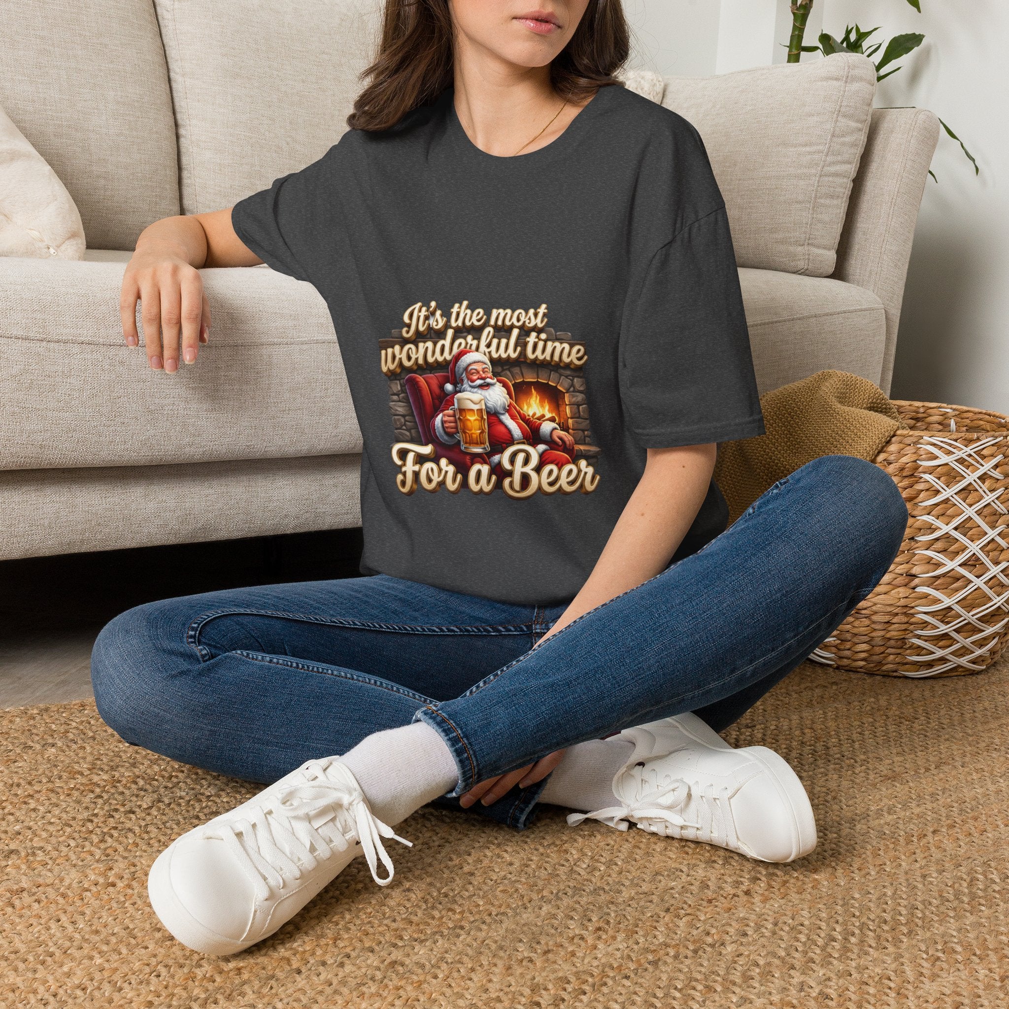 Most Wonderful Time for a Beer Santa t-shirt in Dark Heather, worn by a woman seated on a rug