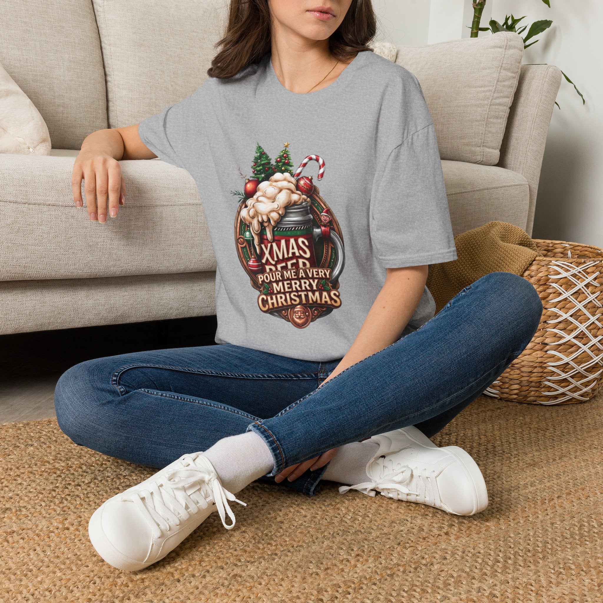 XMAS Beer Pour Me a Very Merry Christmas t-shirt in Sport Grey, worn by a woman seated on a rug
