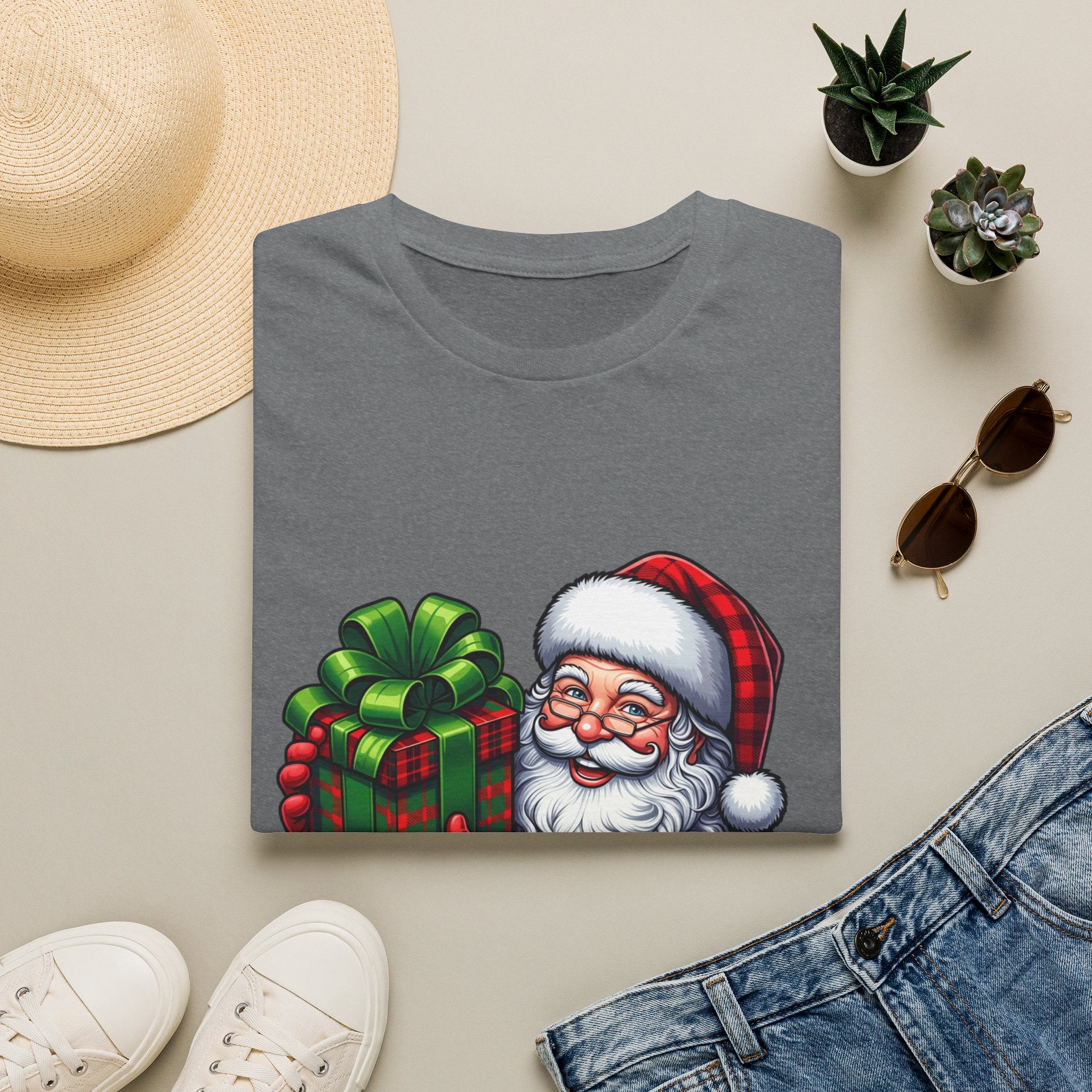 Santa Have a Plaid-astic print on a Graphite Heather t-shirt, folded beside a straw hat and jeans