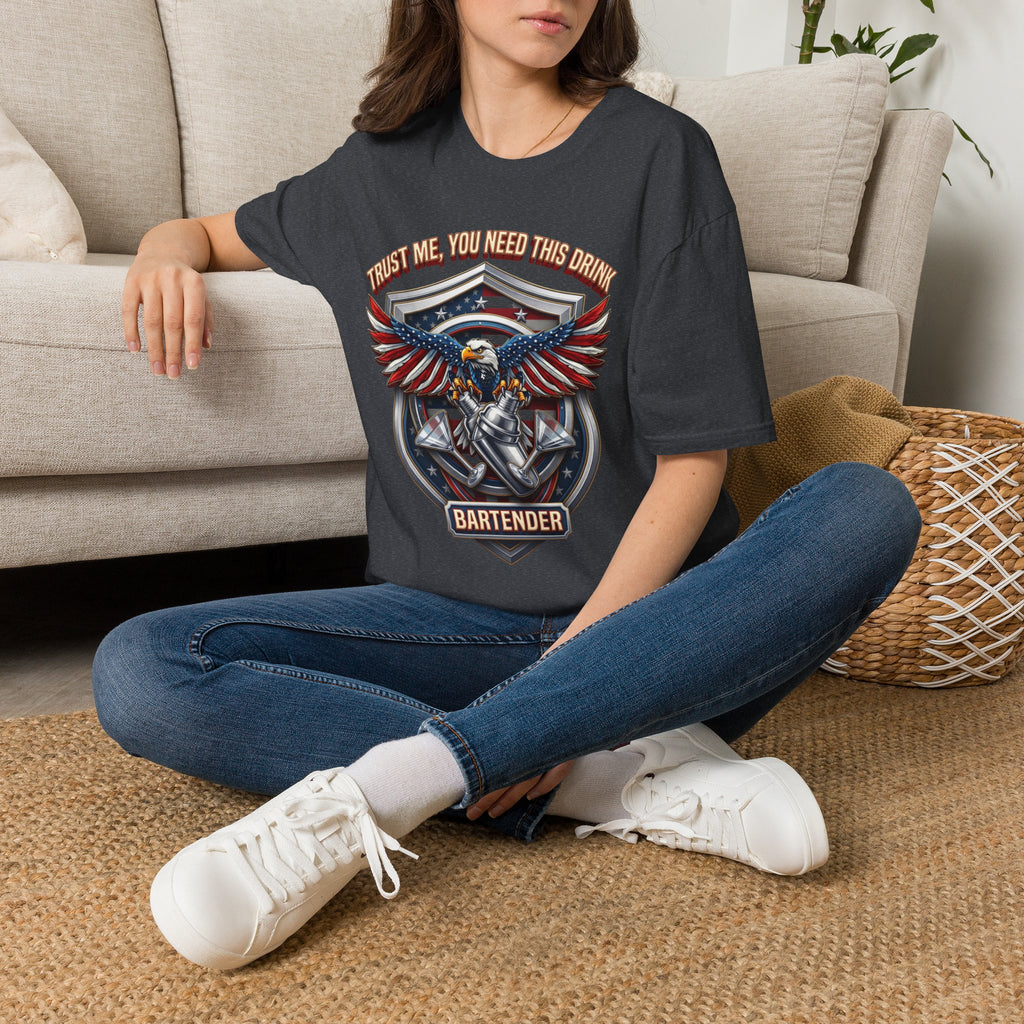 Bartender Eagle Trust Me You Need This Drink t-shirt in Dark Heather Grey, worn by a woman seated on a rug
