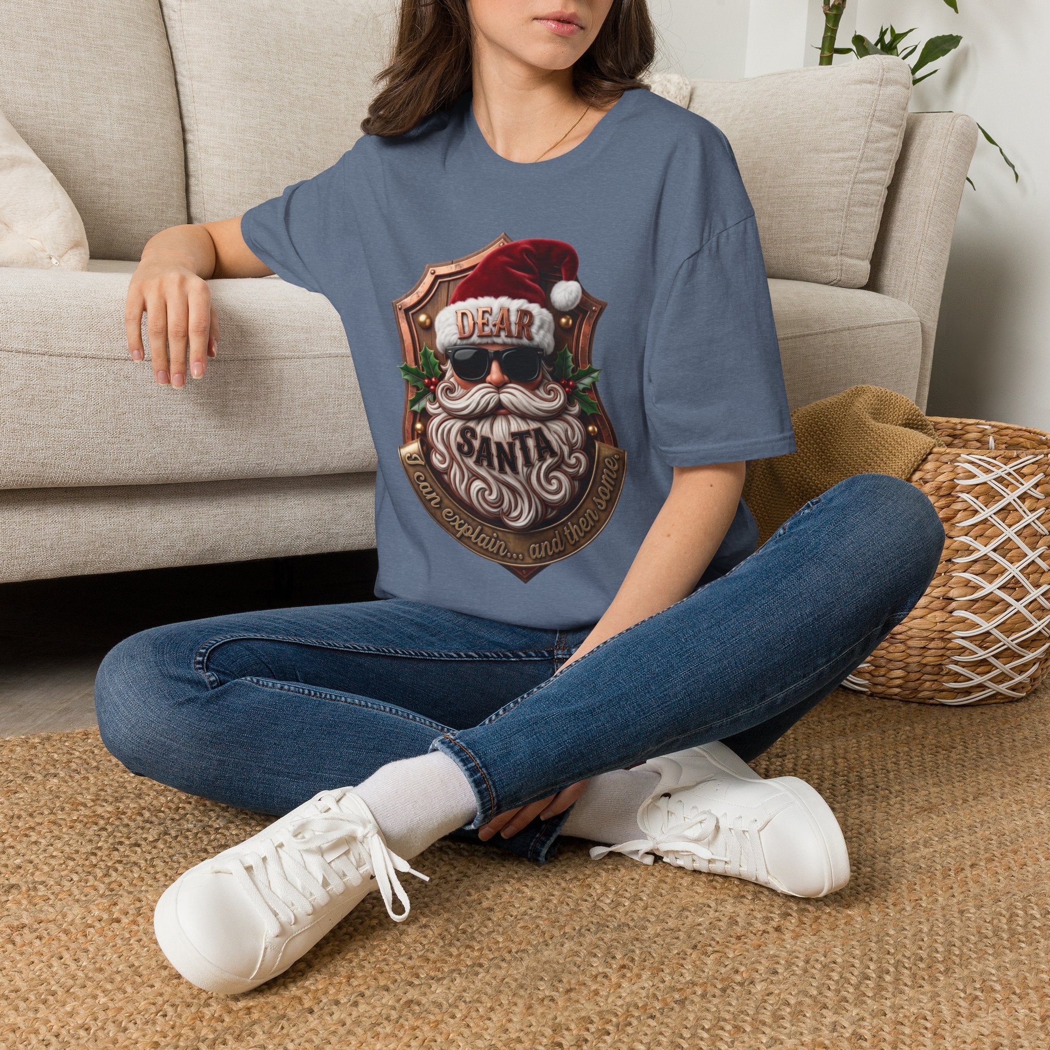 Dear Santa I Can Explain Sunglasses Crest t-shirt in Heather Indigo, worn by a woman seated on a rug