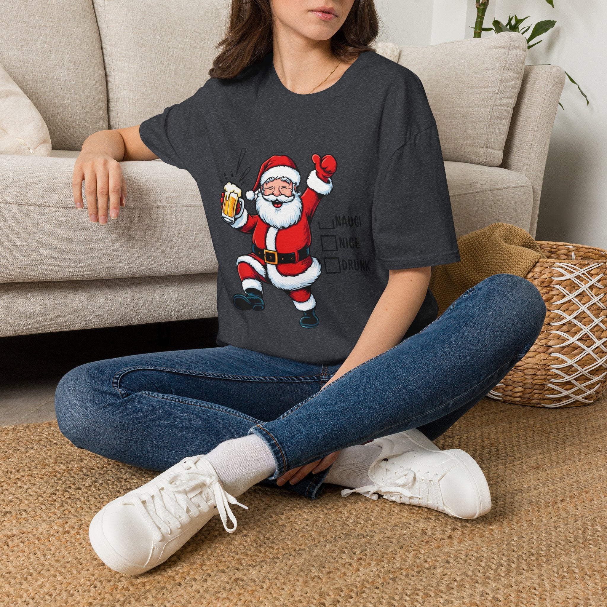 Naughty Nice Drunk Santa Beer Checklist t-shirt in Dark Heather Grey, worn by a woman seated on a rug