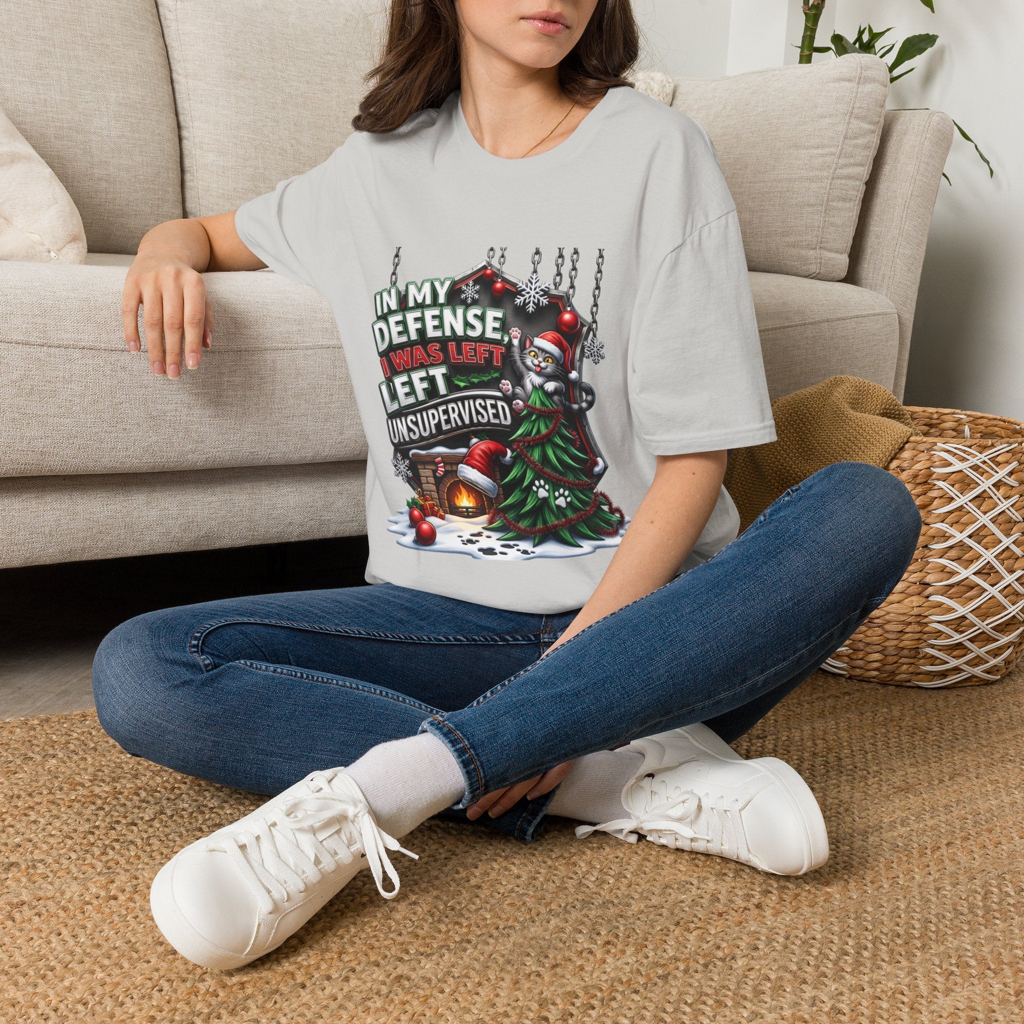 Cat In My Defense Left Unsupervised t-shirt in Ice Grey, worn by a woman seated on a rug