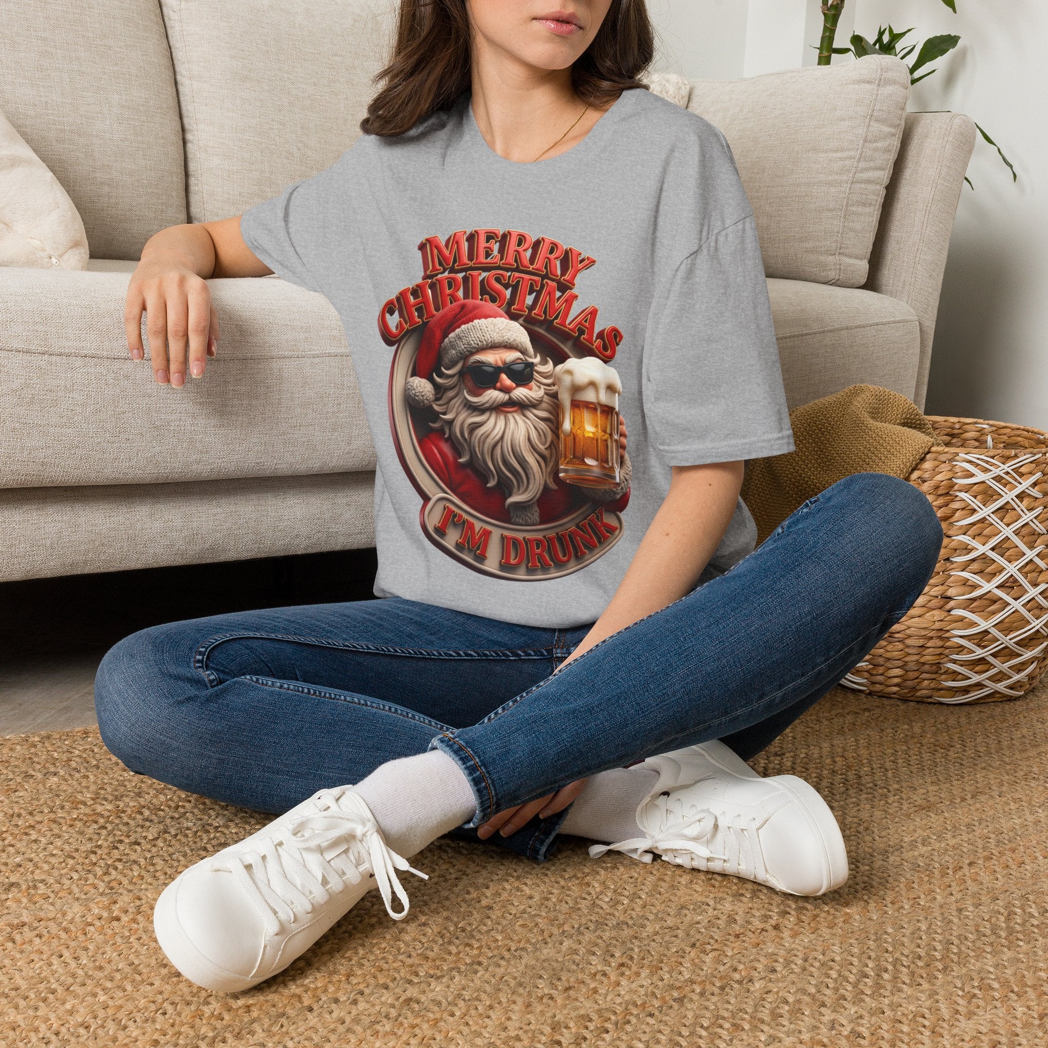 Merry Christmas I'm Drunk Santa t-shirt in Sport Grey, worn by a woman seated on a rug