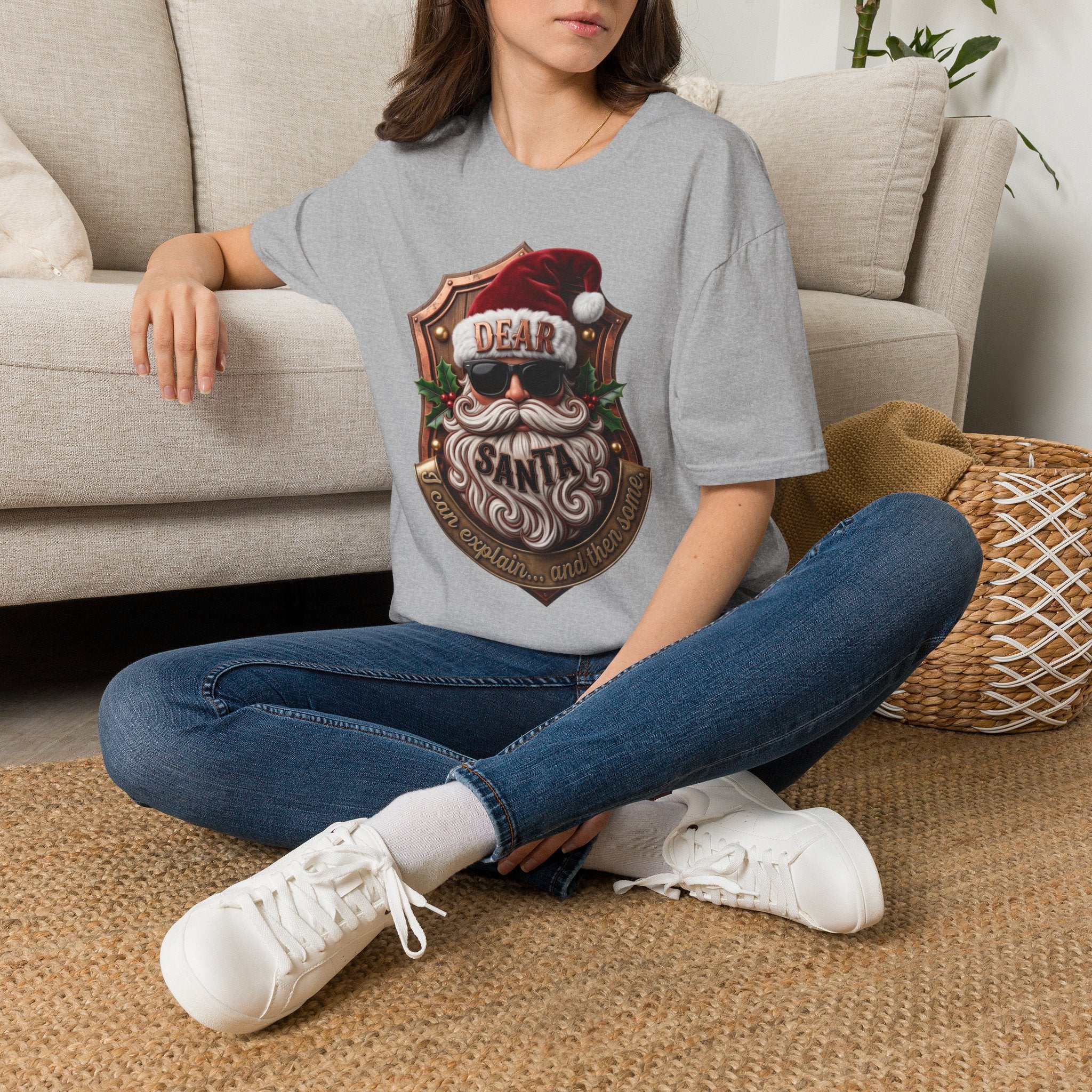 Dear Santa I Can Explain Sunglasses Crest t-shirt in Sport Grey, worn by a woman seated on a rug