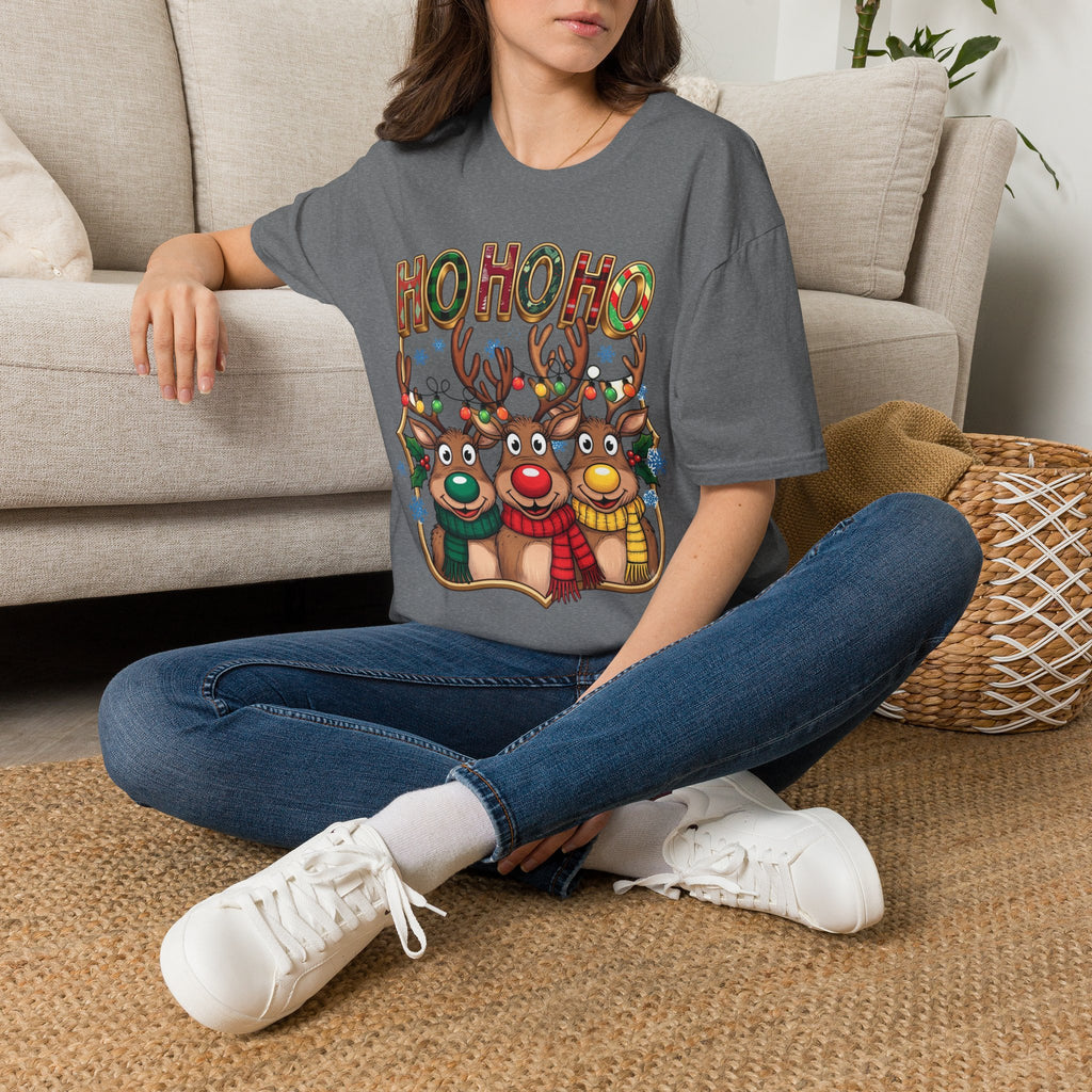 Reindeer Trio Ho Ho Ho Christmas Lights t-shirt in Graphite Heather, worn by a woman seated on a rug